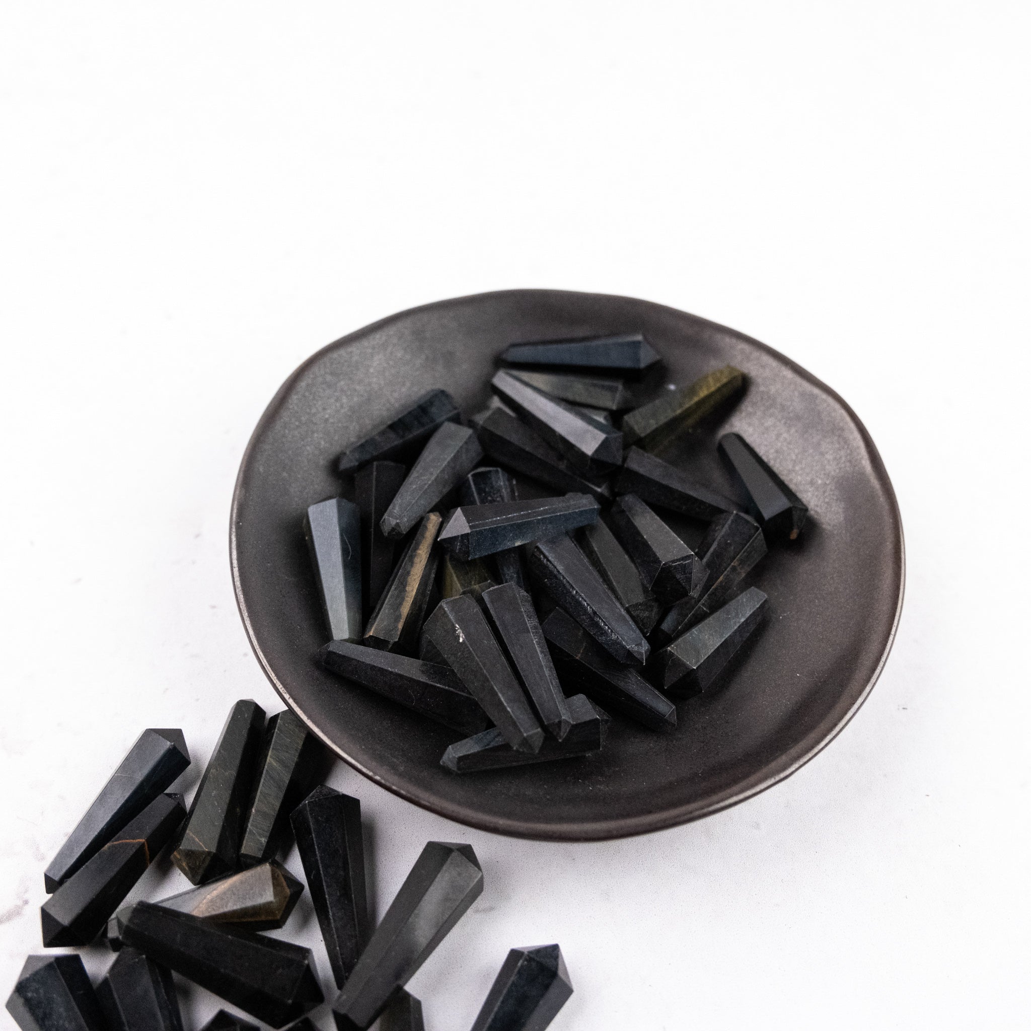 Blue Tigers Eye double gridding point used for jewelry making, featuring a polished, rounded design from Noctis Studio.