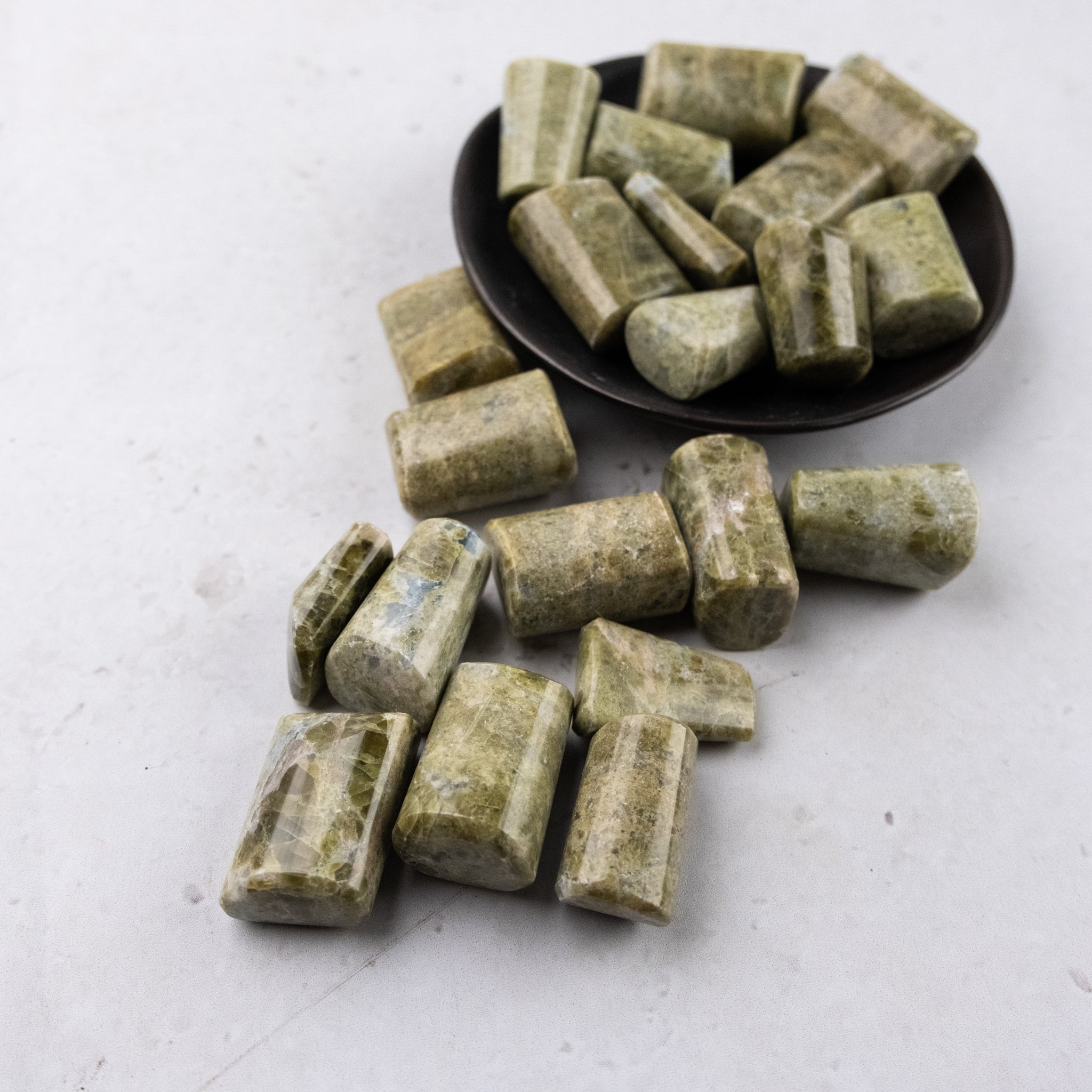 Noctis Studio Vesonite tumble stone with polished, rounded surface showcasing vibrant green and black mineral patterns.