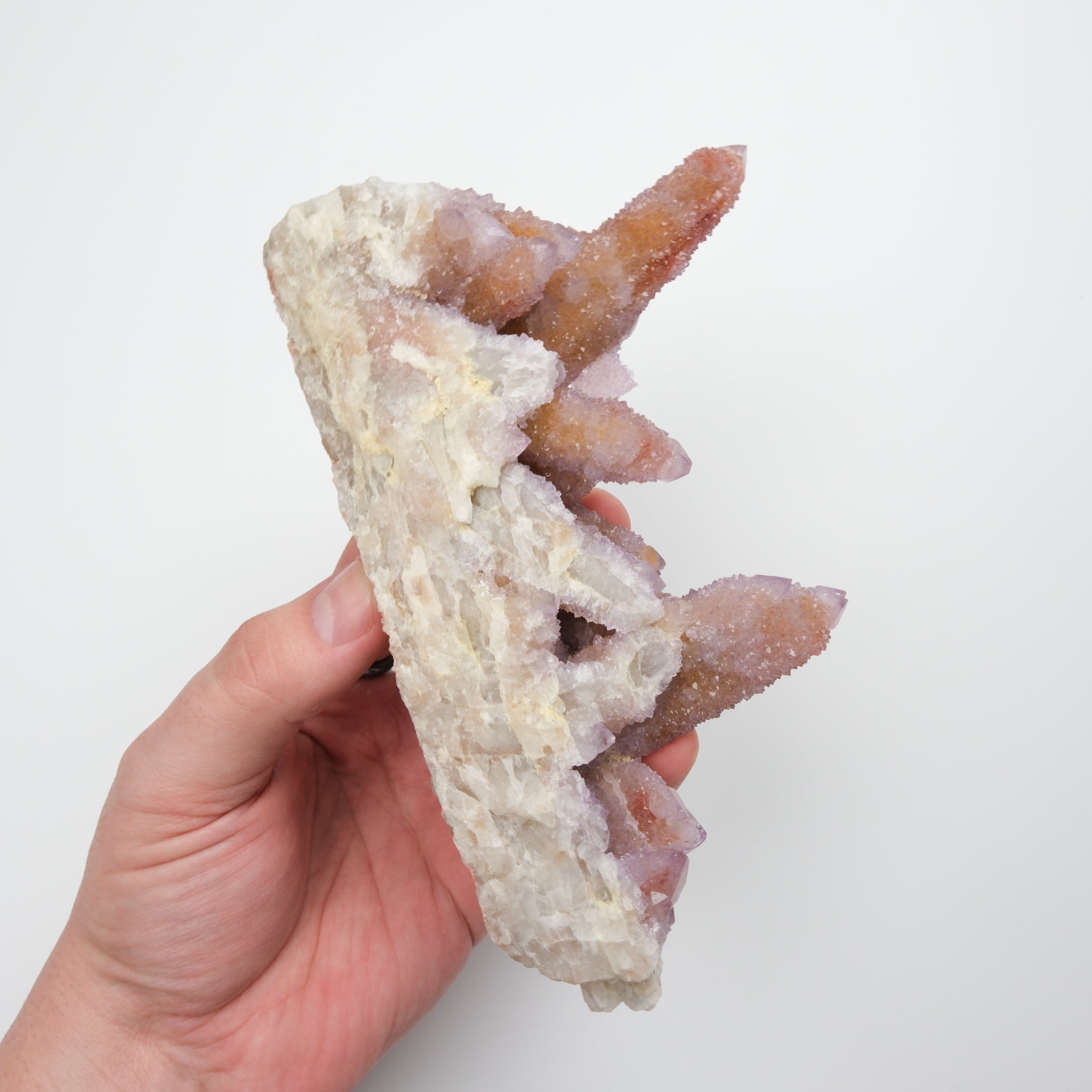 Noctis Studio Spirit Quartz Cluster with multiple clear and purple crystal points on a natural mineral base.