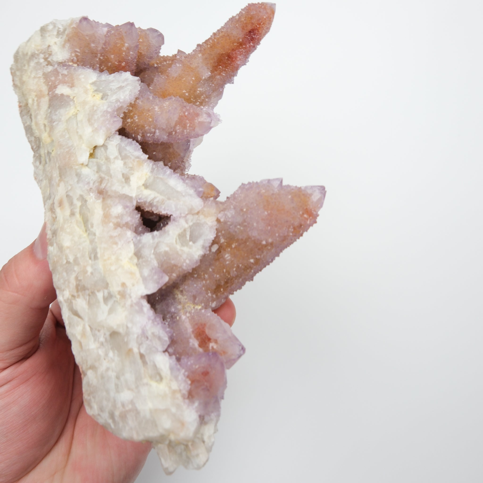 Noctis Studio Spirit Quartz Cluster featuring multiple clear, hexagonal crystals with a shimmering, iridescent appearance.