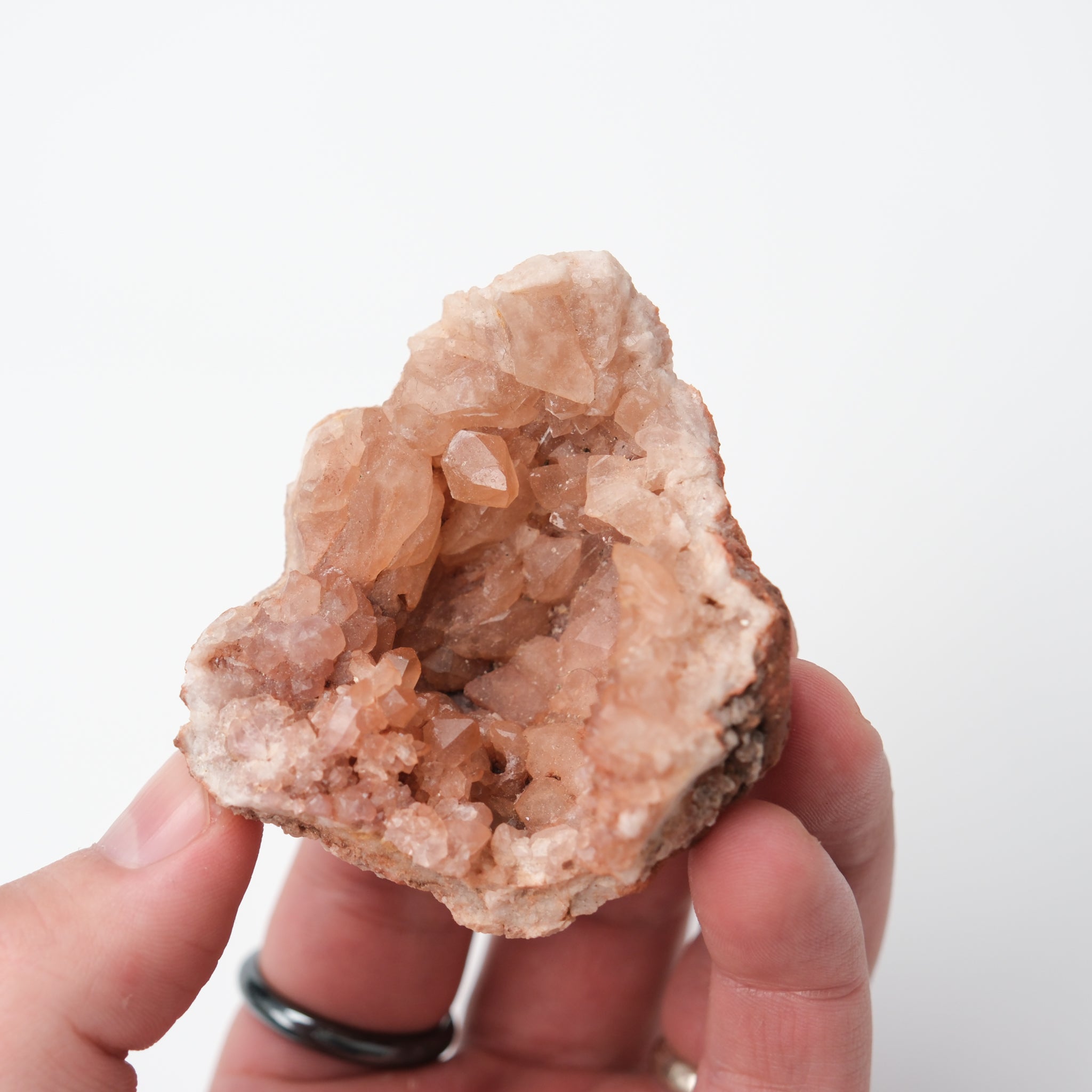 Pink Amethyst geode from Noctis Studio, showcasing vibrant pink crystals and a rugged natural rock exterior.