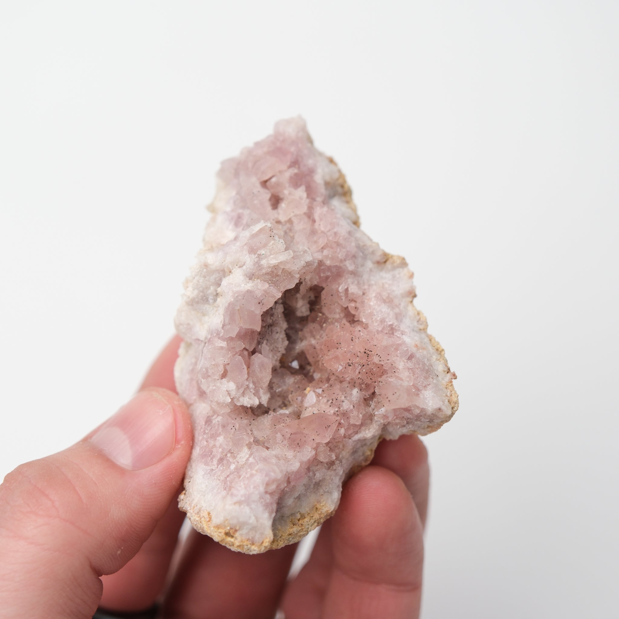 Pink Amethyst Geode from Noctis Studio showing vibrant purple crystals inside a rough rock cavity.