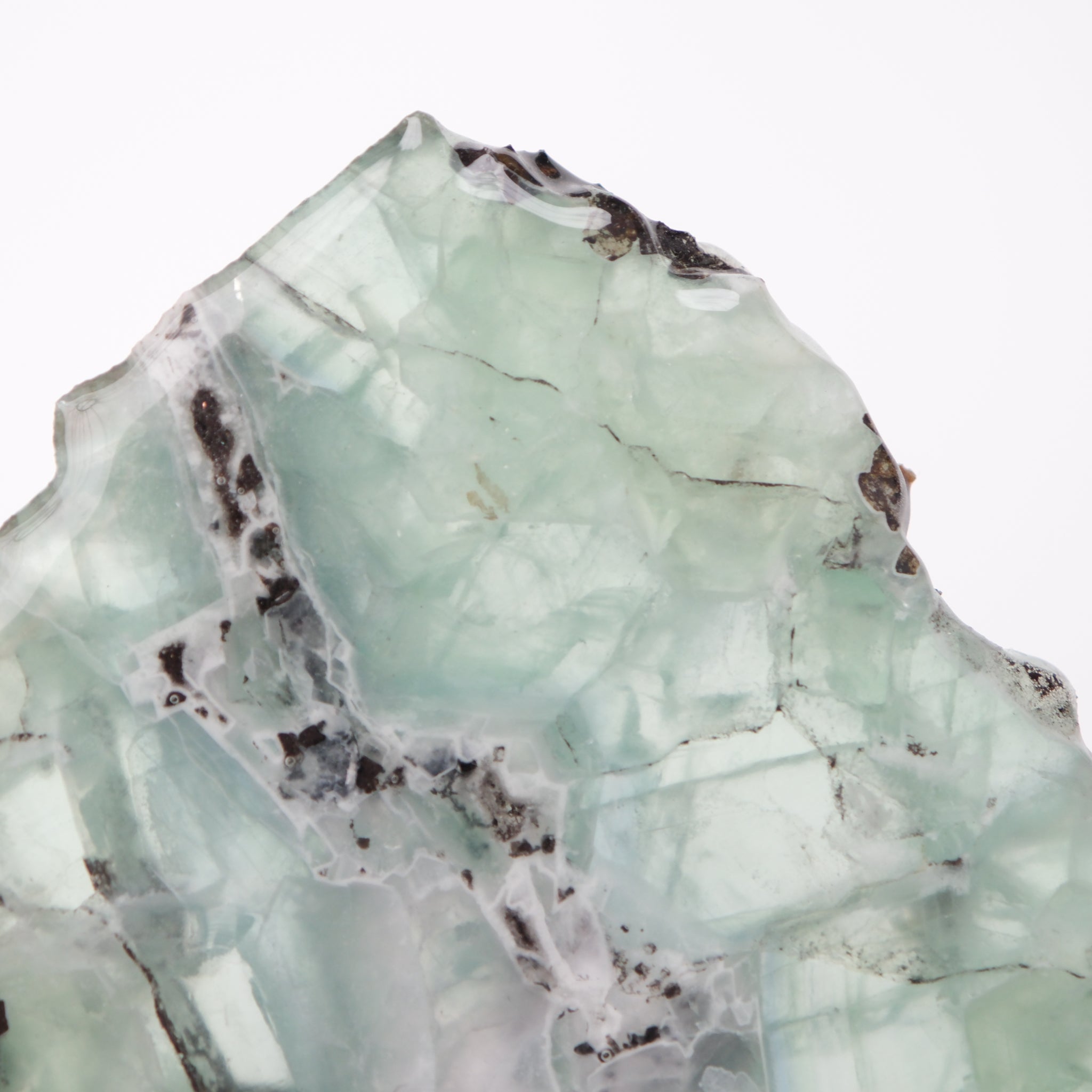 Vivid fluorite slab with vibrant green and purple hues, showcasing natural mineral patterns and polished surface from Noctis Studio.