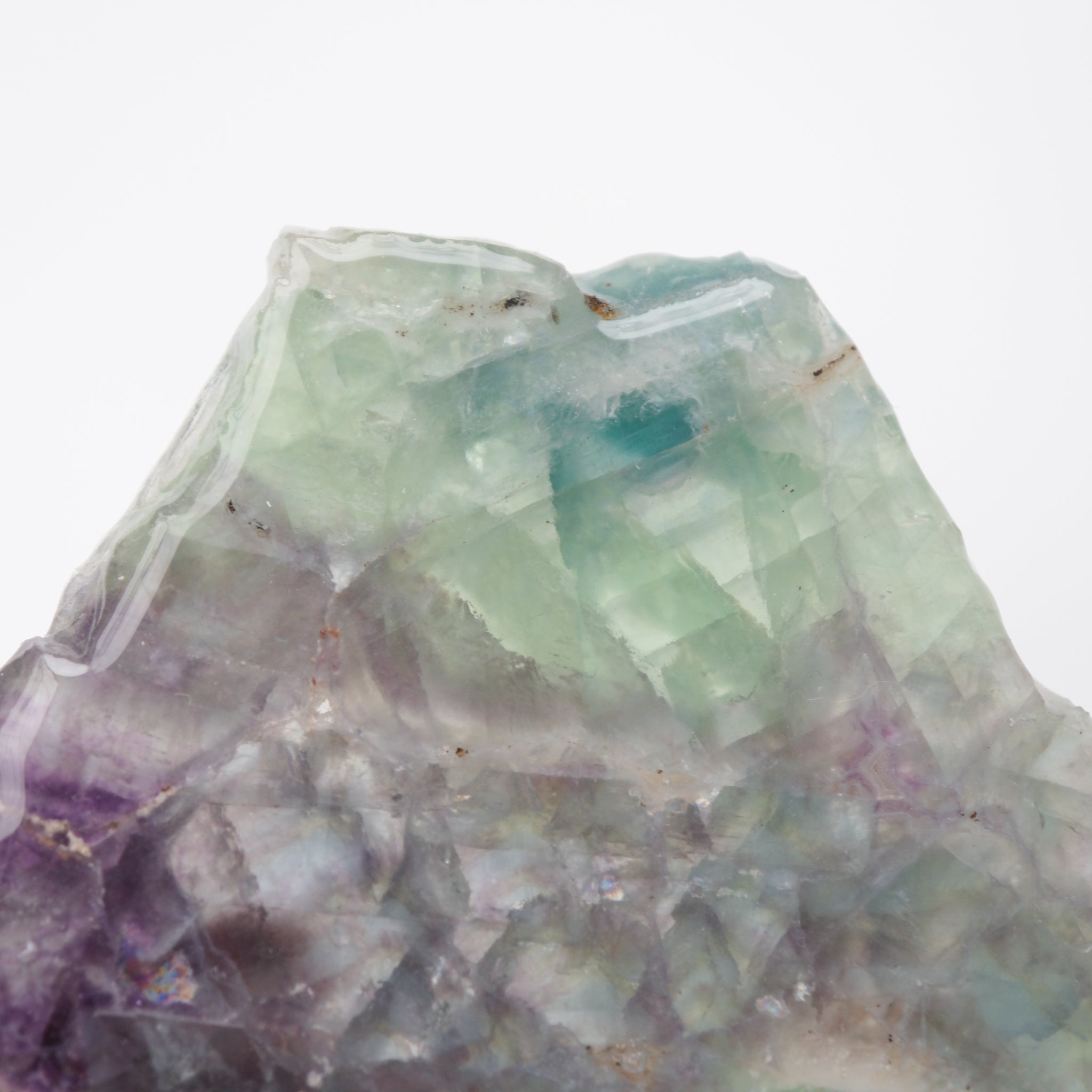Colorful fluorite slab from Noctis Studio showcasing vibrant bands and natural crystal formations on a polished surface.