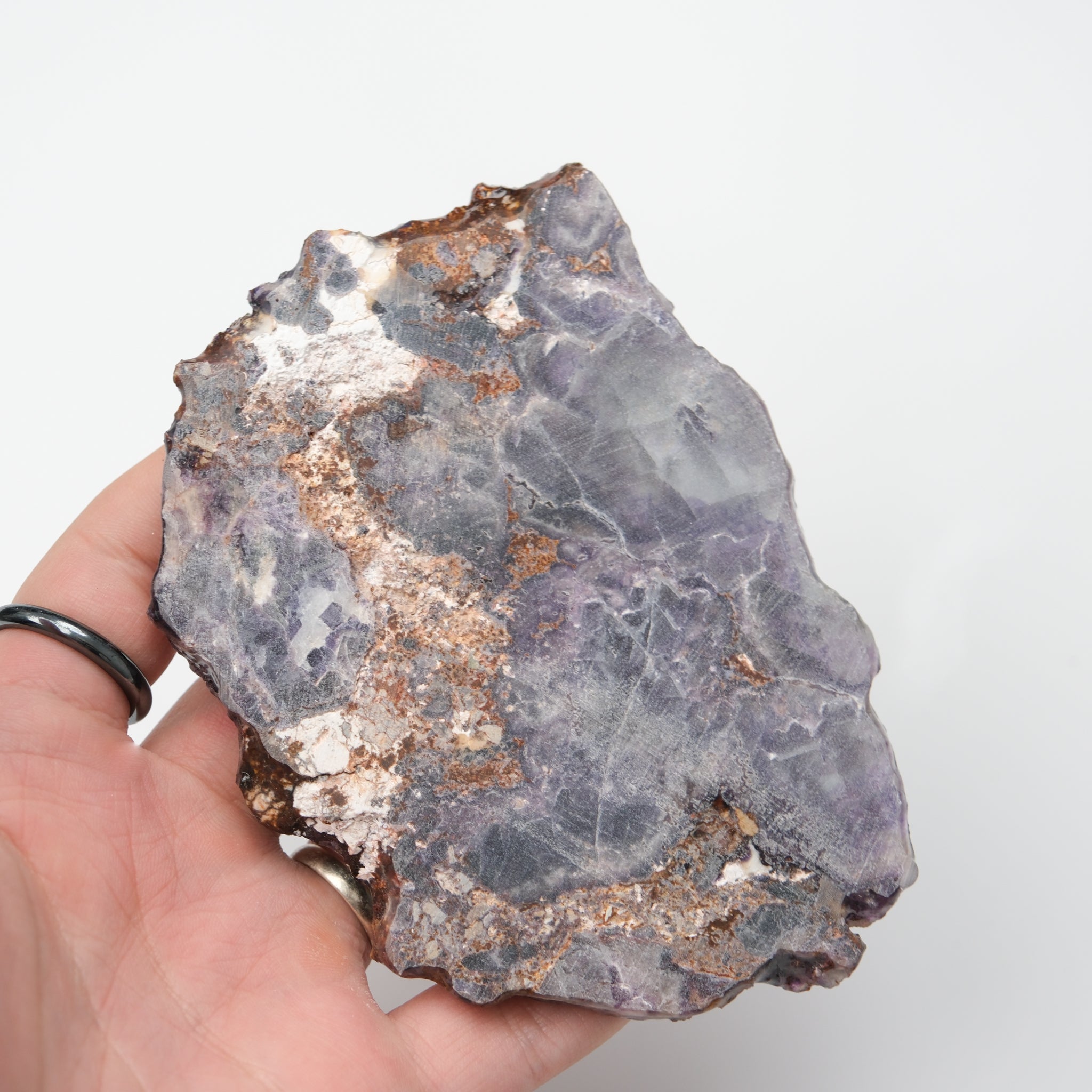 Colorful fluorite slab by Noctis Studio showcasing vibrant green, purple, and clear mineral layers with a polished surface.
