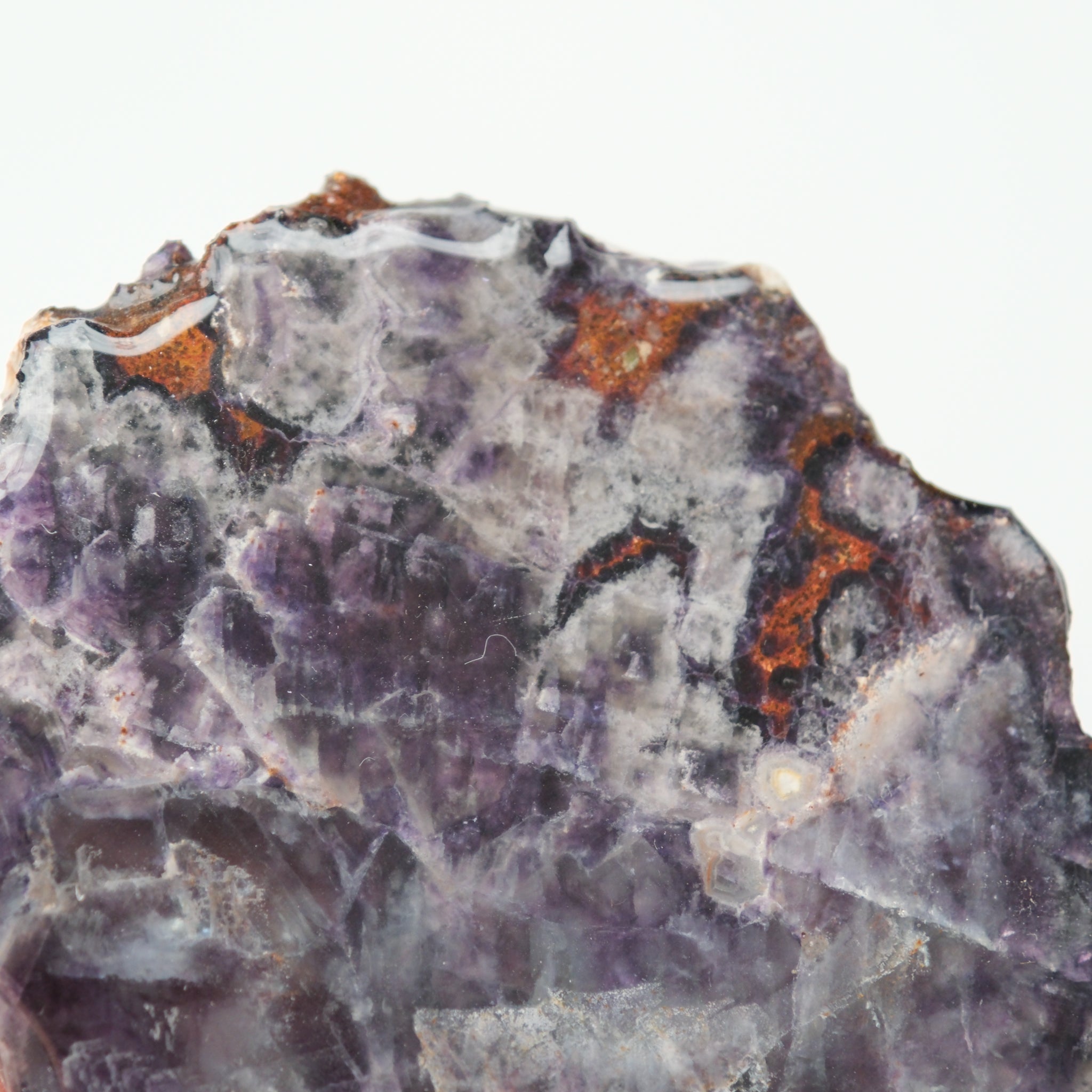 Colorful fluorite slab from Noctis Studio showing vibrant green, purple, and blue hues with natural mineral banding.