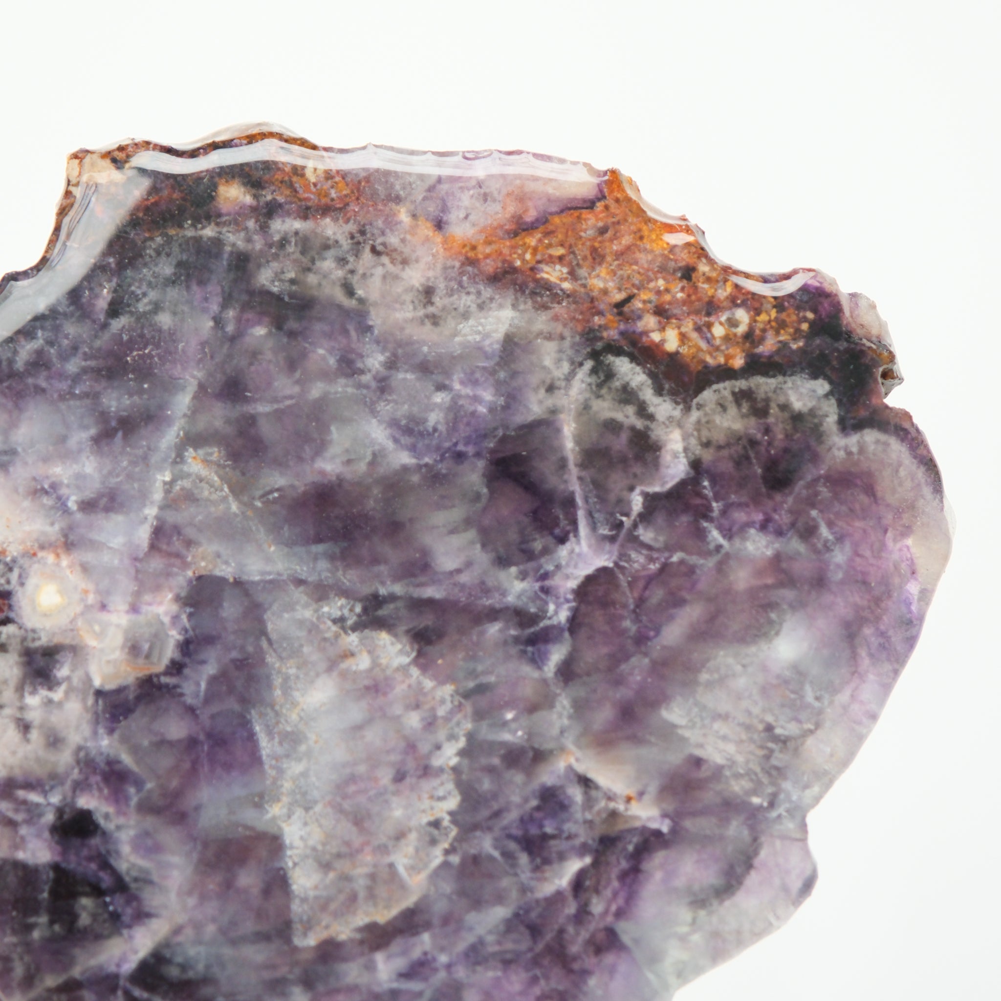 Noctis Studio fluorite slab with vibrant green and purple mineral patterns, smooth polished surface, and natural crystal formations.
