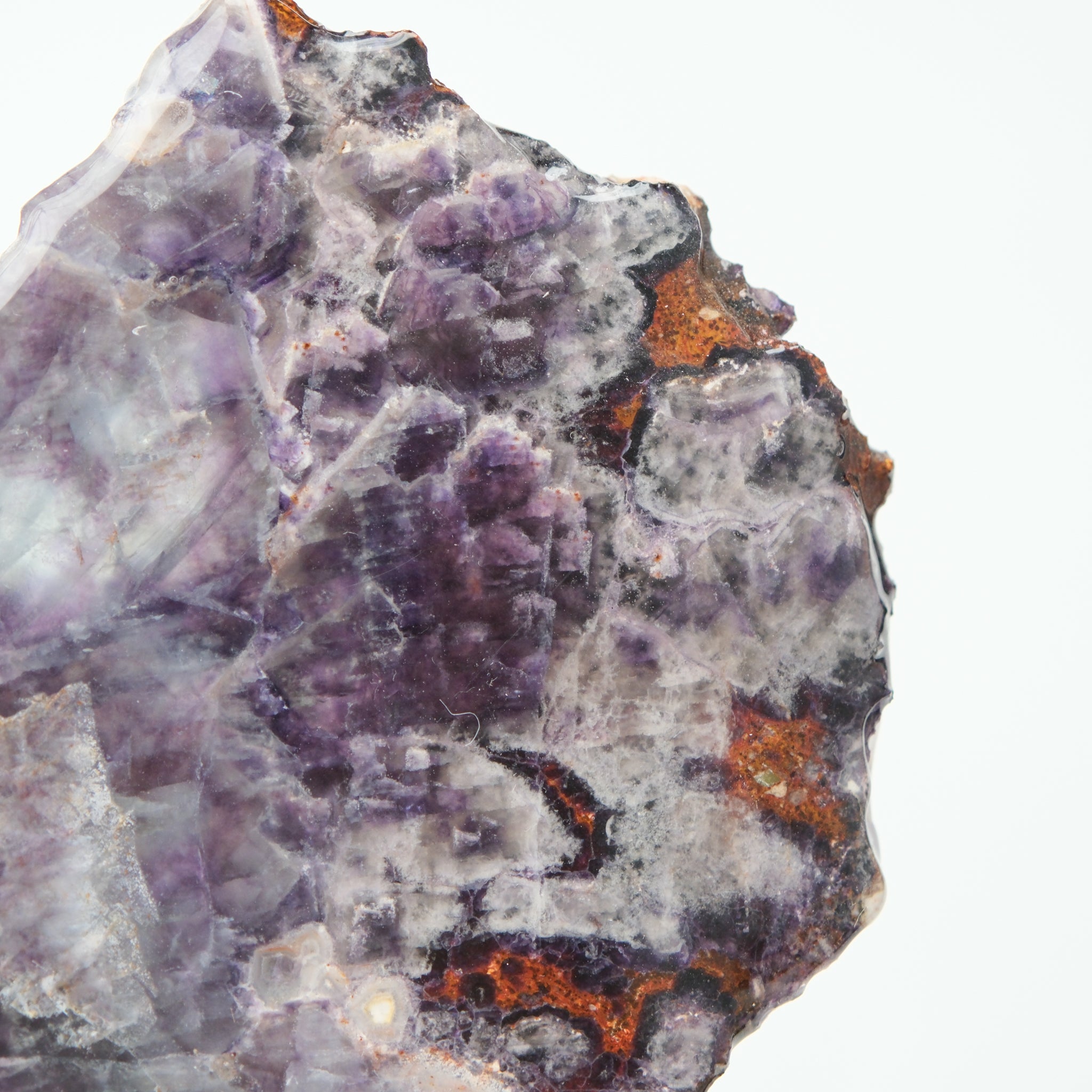 Noctis Studio fluorite slab showing vibrant green and purple mineral layers with smooth, polished surface details.