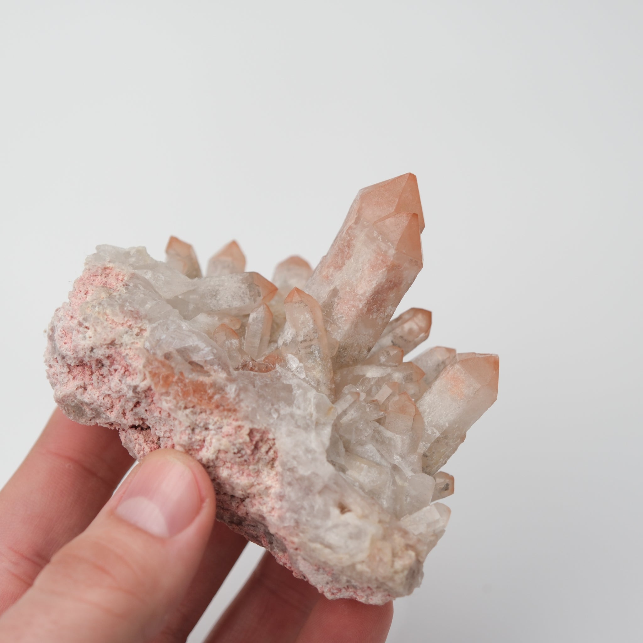 Orange River Quartz Cluster from Noctis Studio showing vibrant orange crystal points arranged in a natural mineral formation.