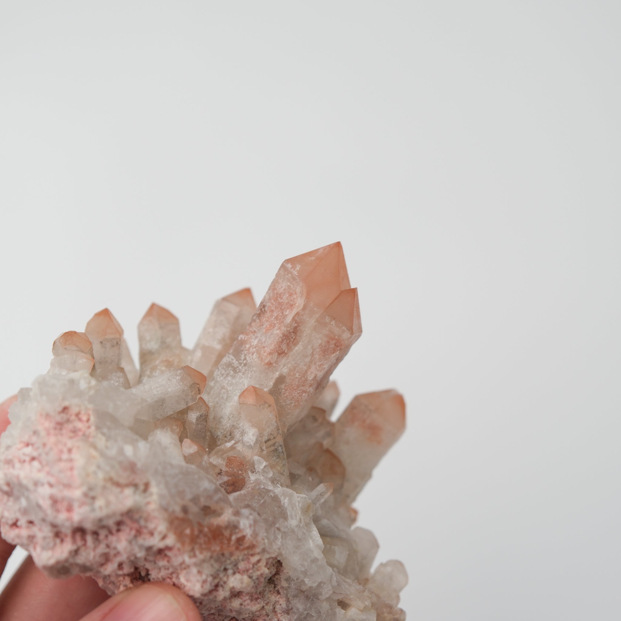 Orange River Quartz Cluster from Noctis Studio showing vibrant orange quartz crystals in a natural cluster formation.