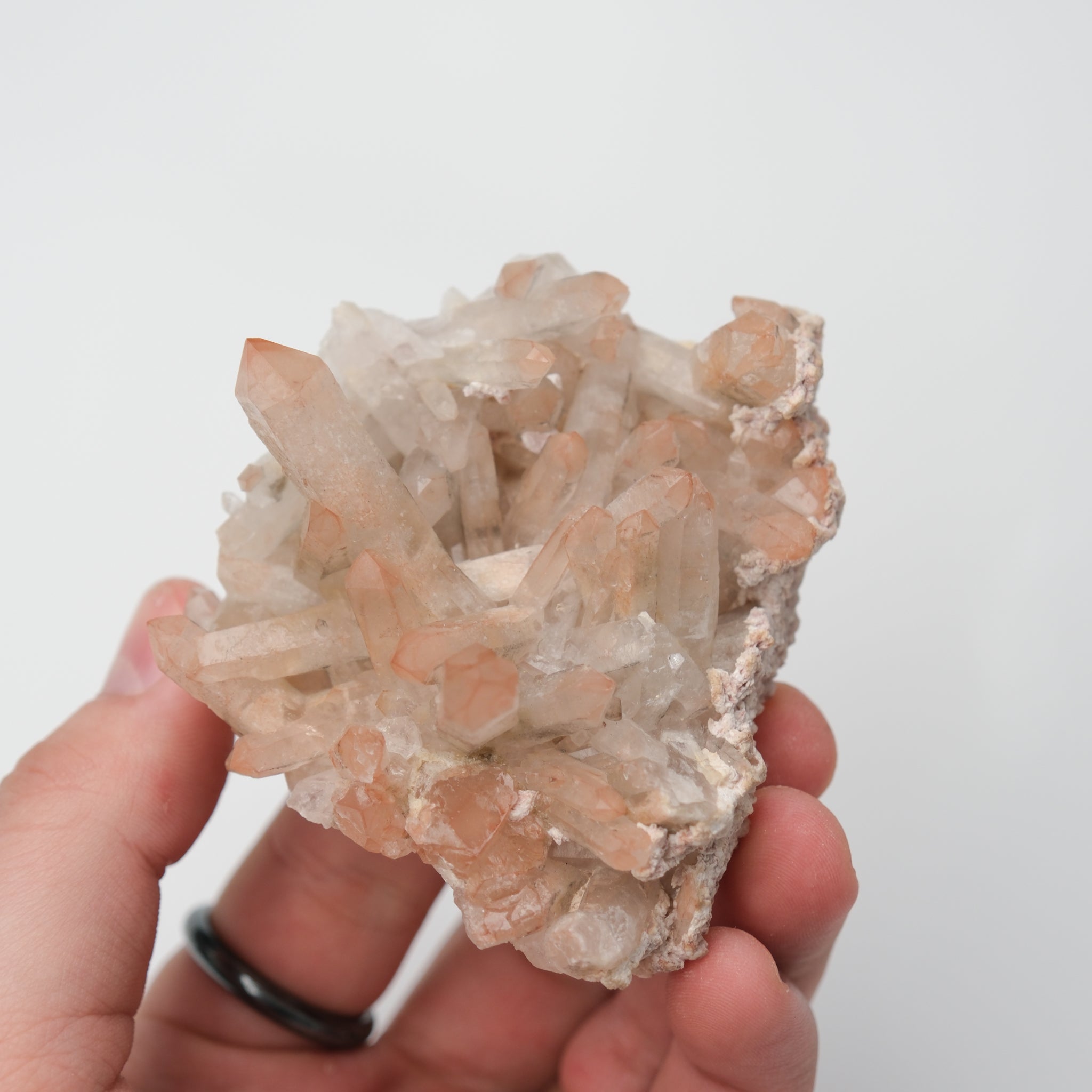 Orange River Quartz Cluster from Noctis Studio featuring vibrant orange quartz crystals arranged in a natural mineral formation.