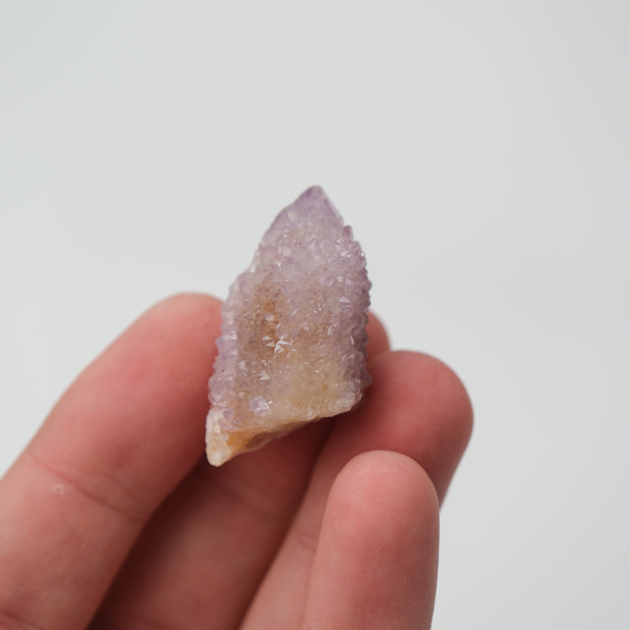 Noctis Studio Spirit Quartz cluster with clear, elongated crystal formations and vibrant natural hues on a neutral background.
