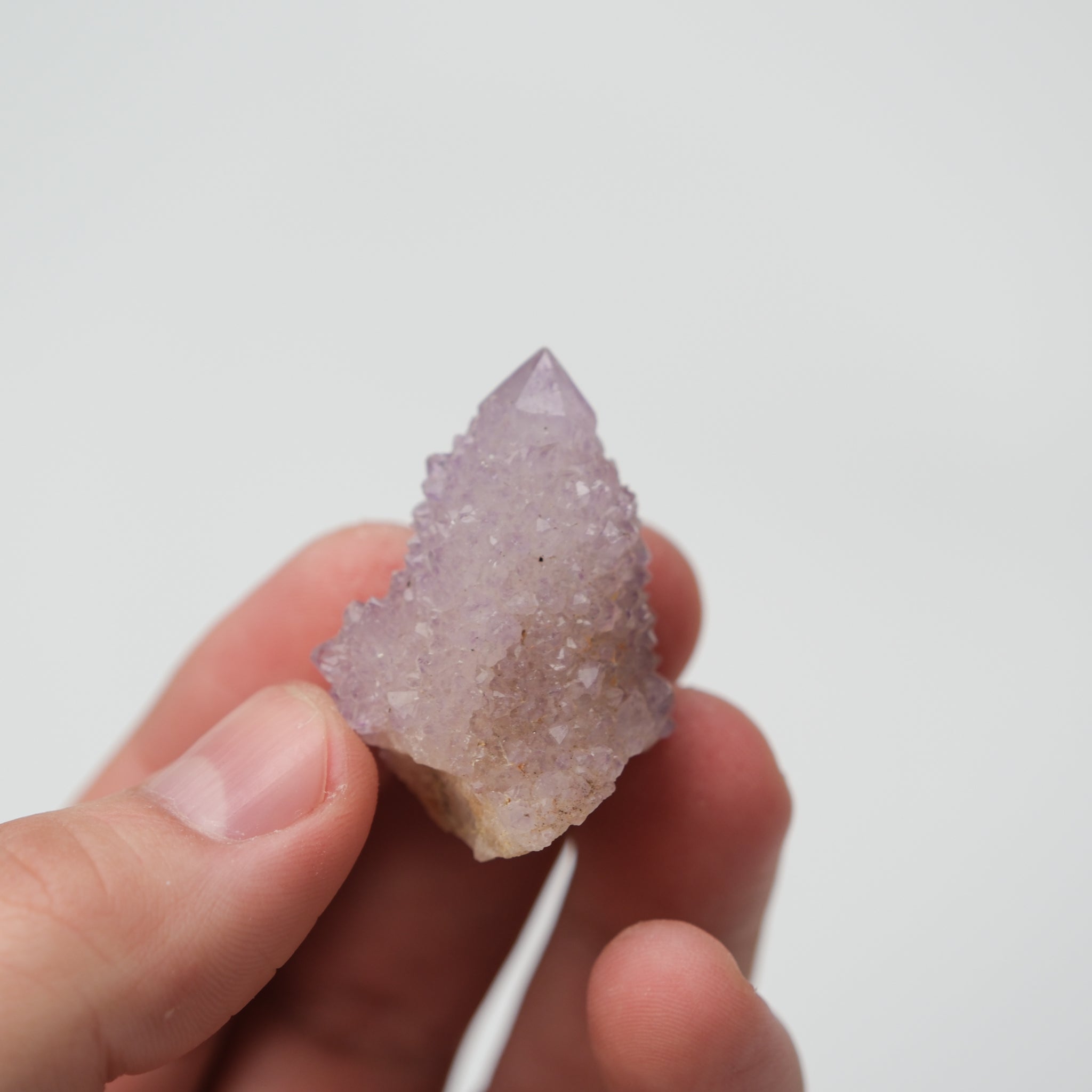 Natural spirit quartz cluster with clear and smoky quartz crystals, featuring a vibrant, multi-colored appearance from Noctis Studio.