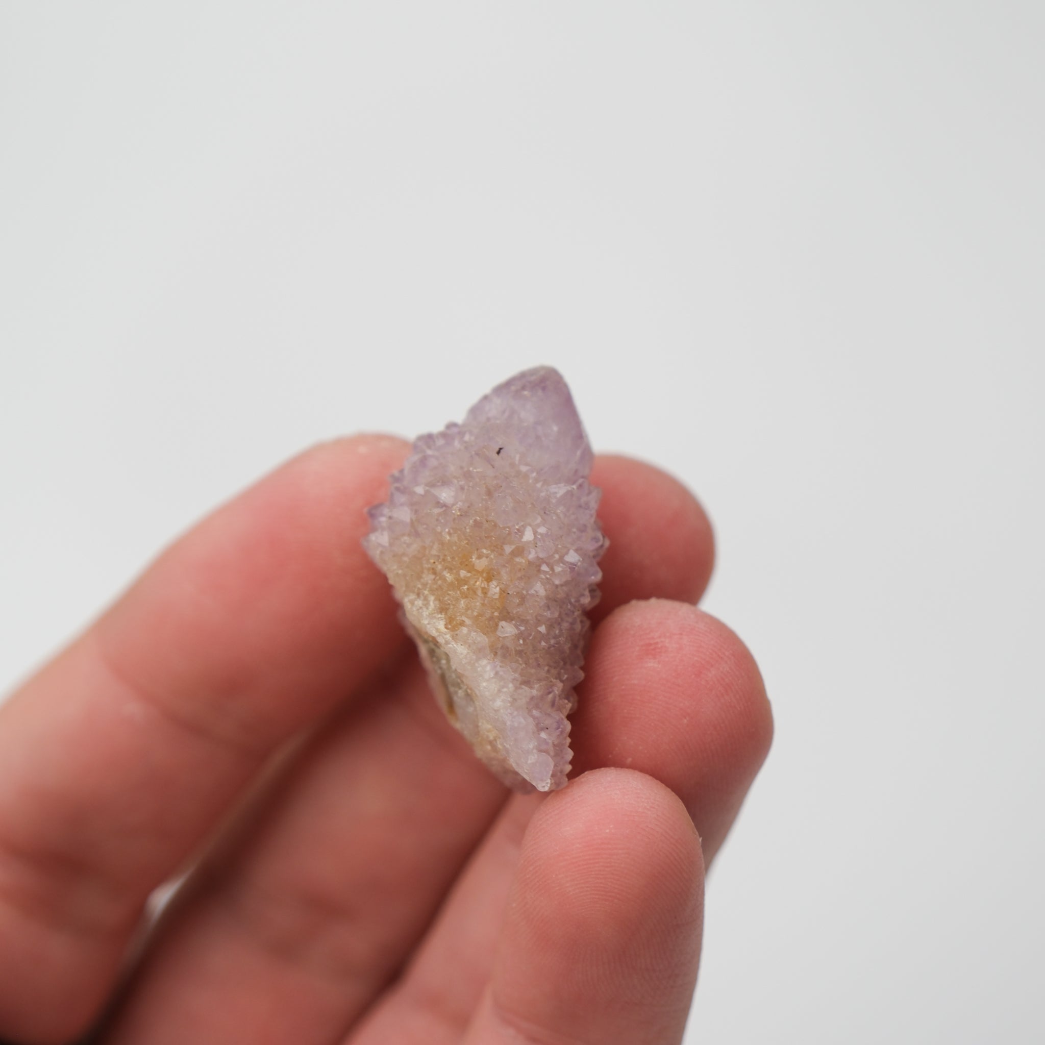 Natural spirit quartz cluster from Noctis Studio showing multiple translucent, pastel-colored quartz points arranged together.