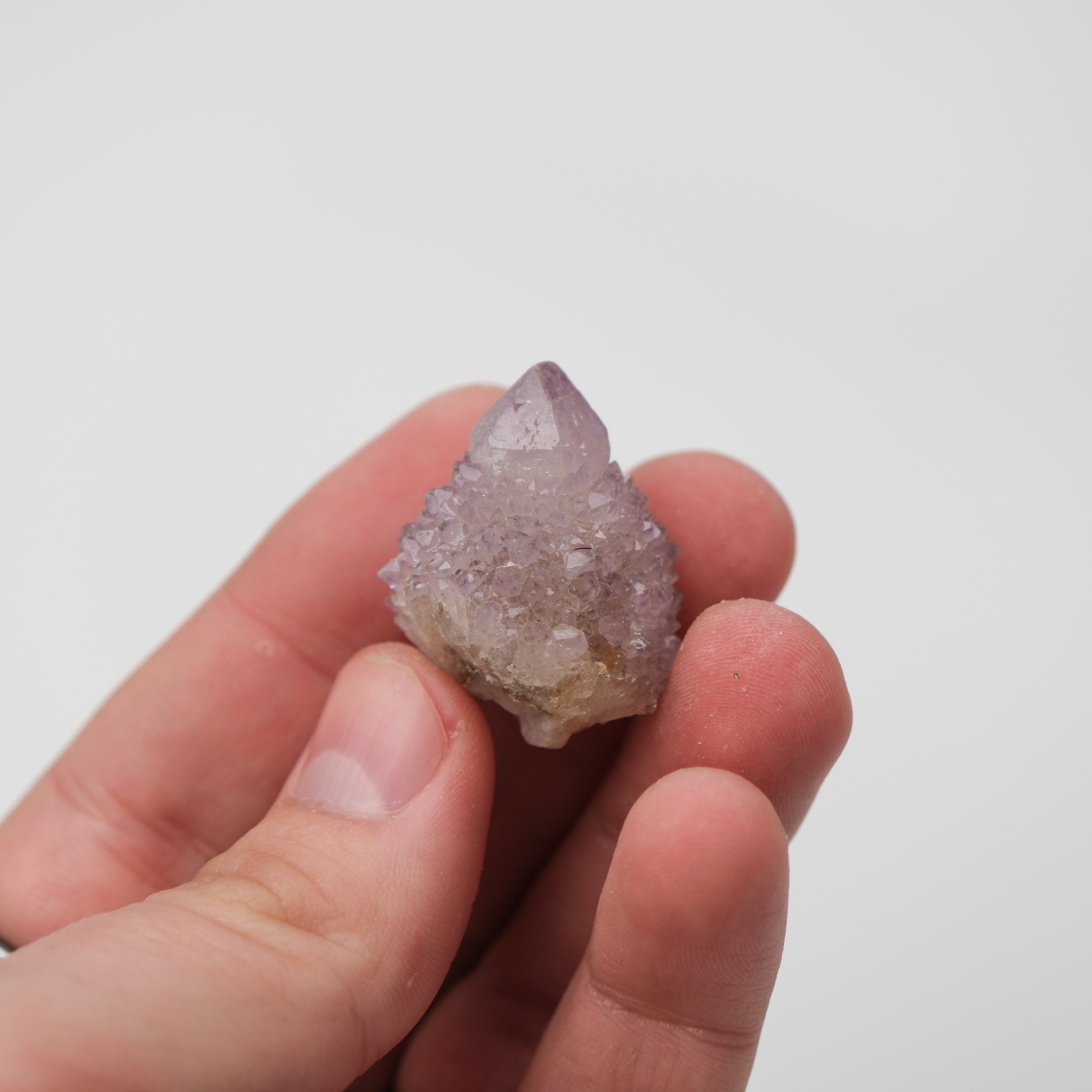 Noctis Studio Spirit Quartz cluster with clear, elongated crystals arranged in a natural formation with a silvery sheen.