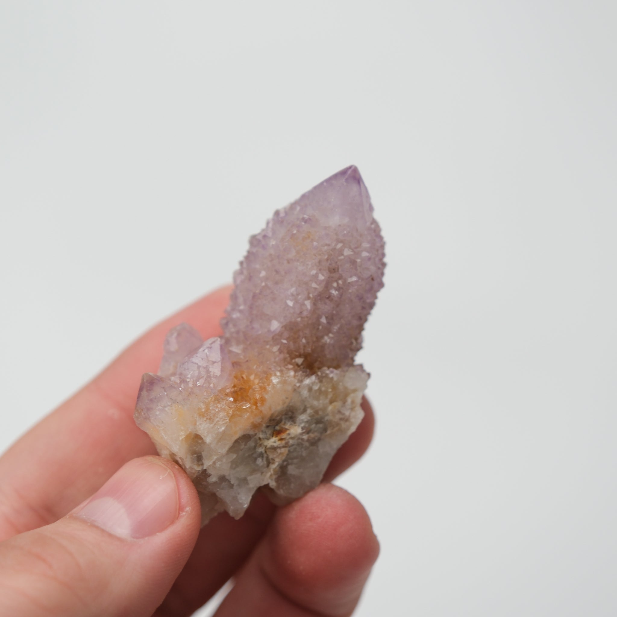 Noctis Studio Spirit Quartz cluster with clear, elongated crystals arranged in a natural formation on a neutral background.