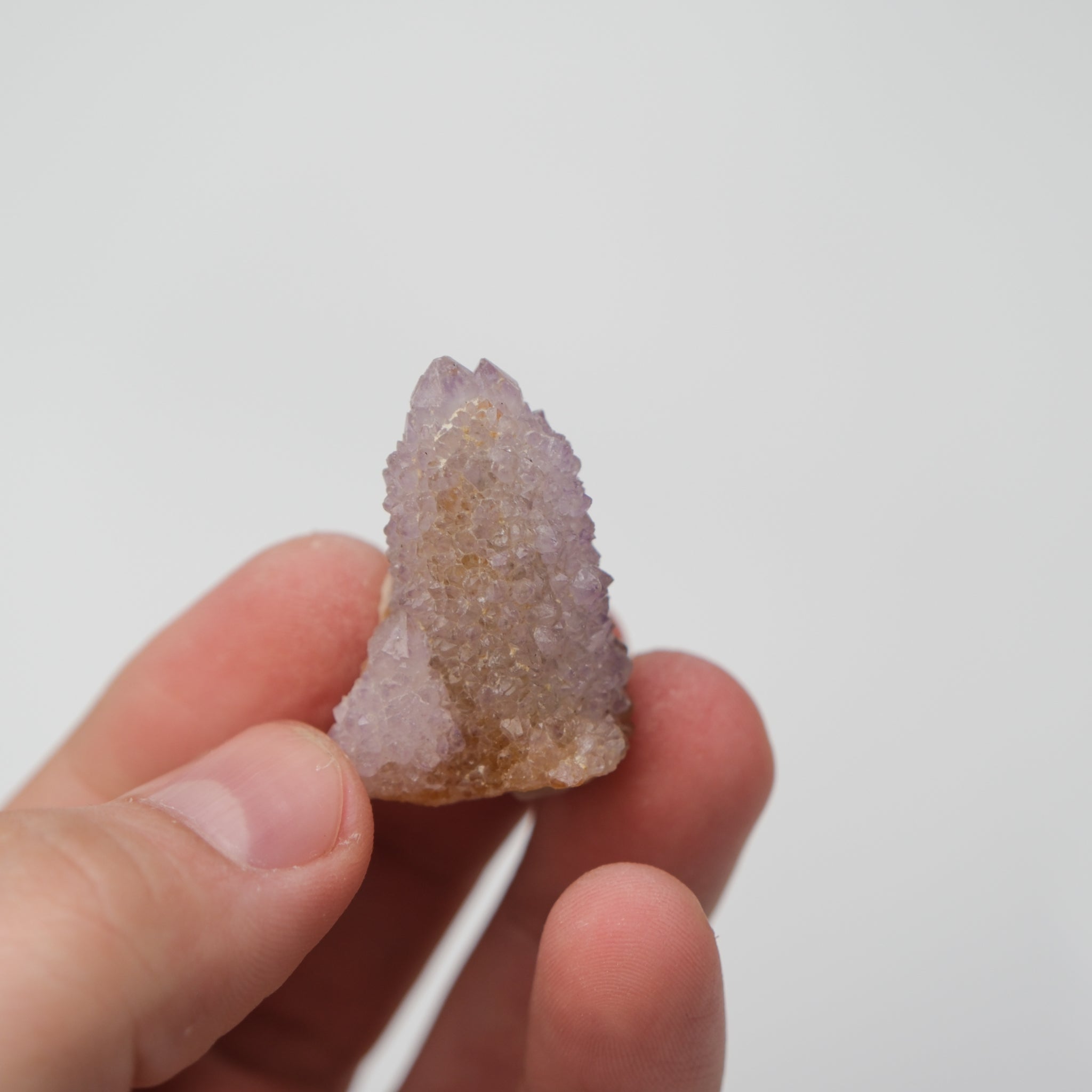 Noctis Studio Spirit Quartz cluster with multiple clear, purple-tinted crystal points on a white background.