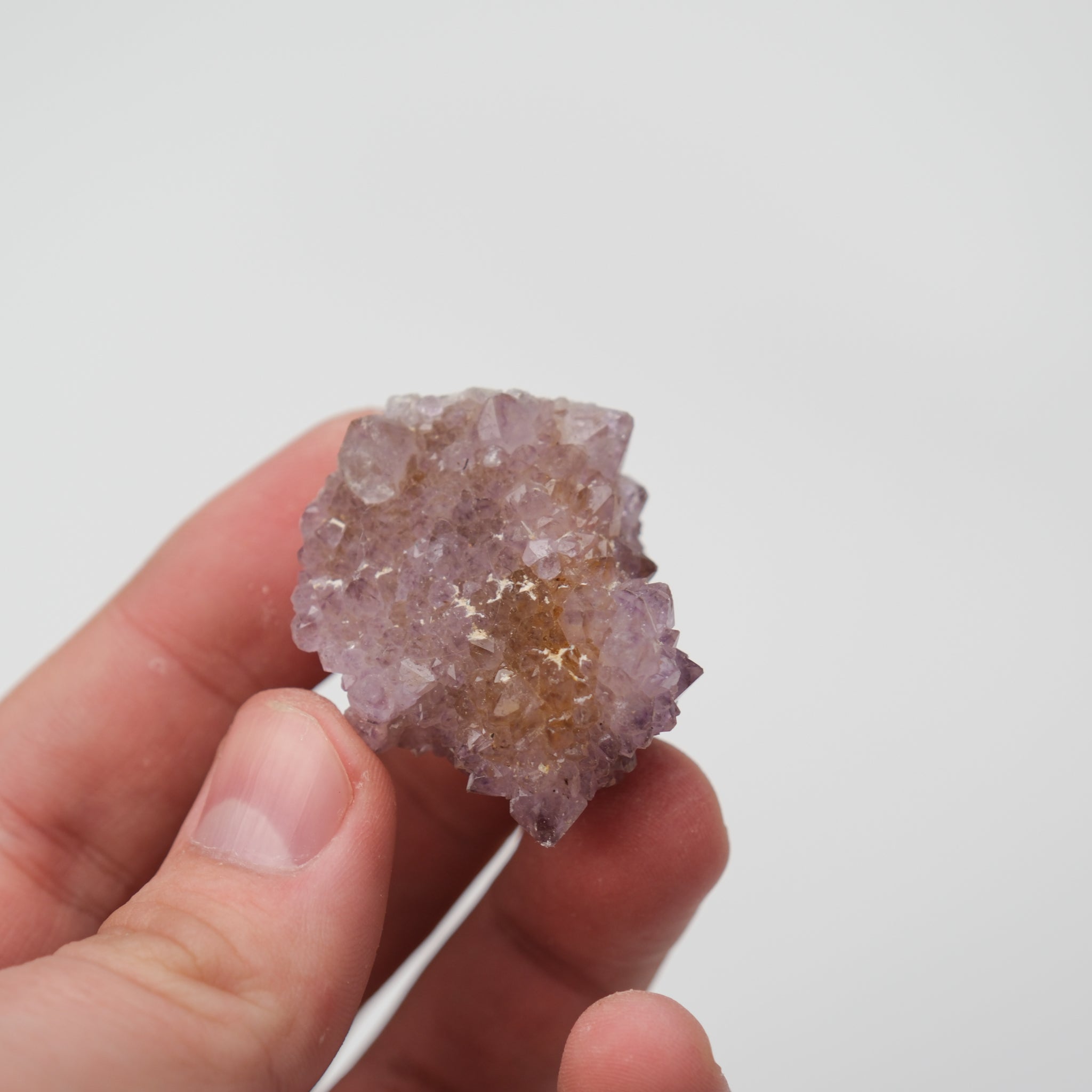 Noctis Studio spirit quartz cluster with multiple translucent purple and clear crystal points on a natural base.