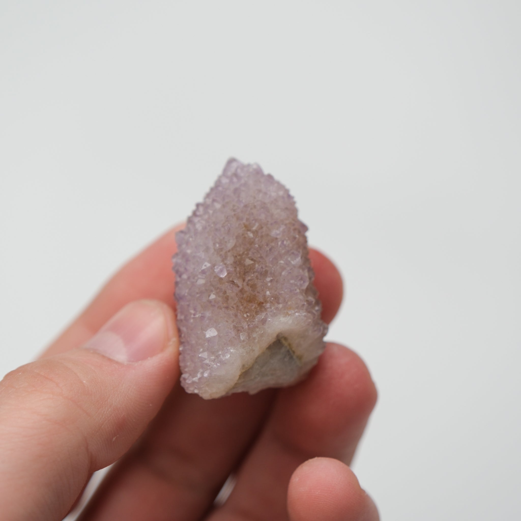 Noctis Studio Spirit Quartz cluster with clear, pointed crystals arranged in a natural formation on a neutral background.