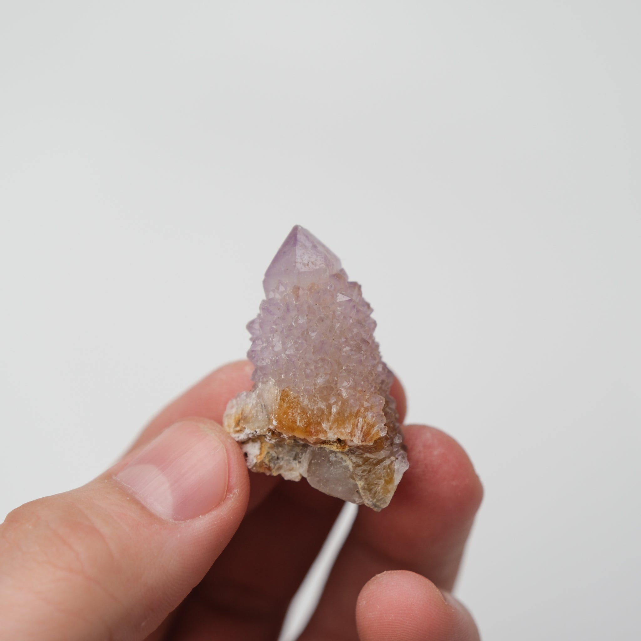 Noctis Studio Spirit Quartz cluster with multiple clear, lavender, and smoky quartz crystals arranged in a natural formation.
