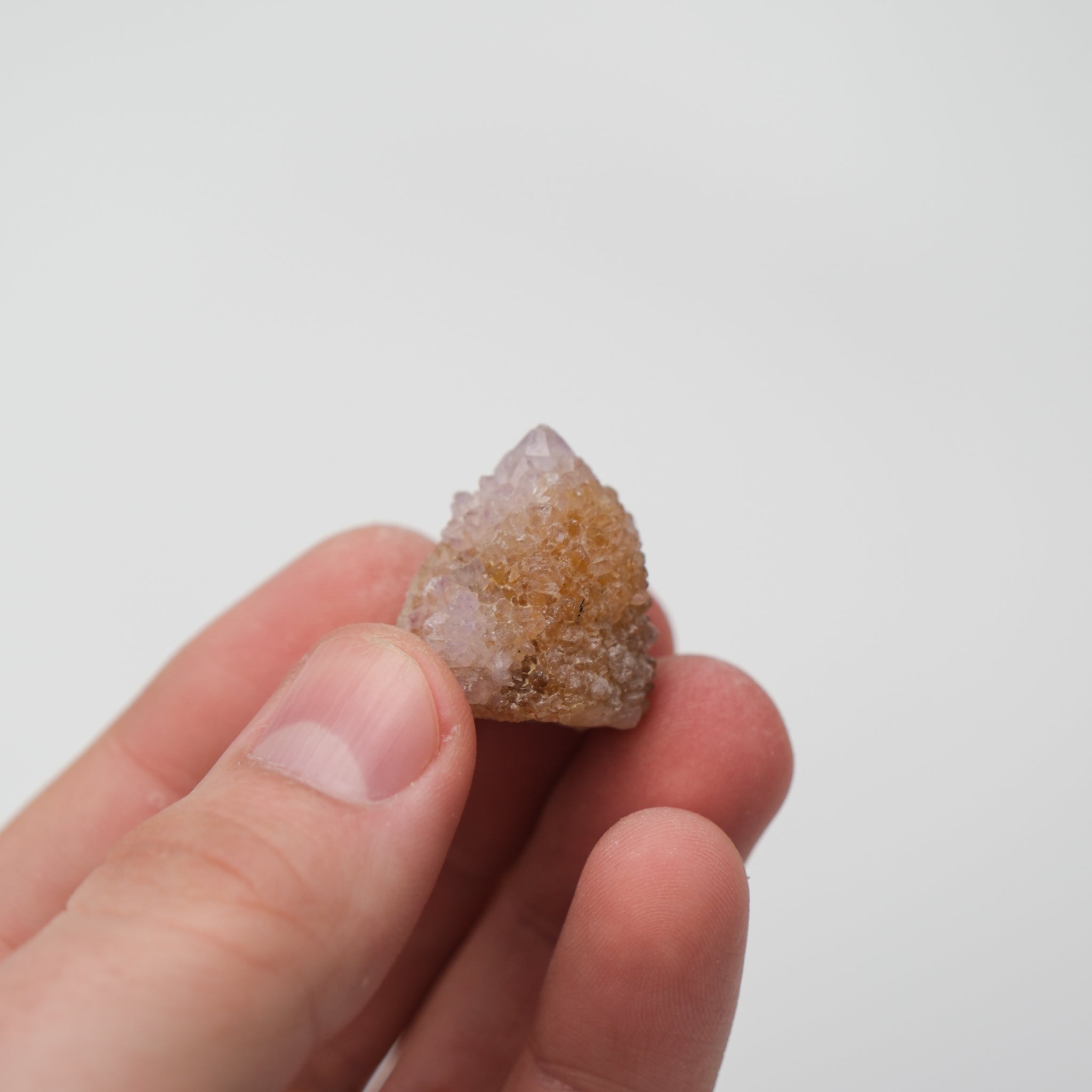 Large spirit quartz cluster with clear, pointed crystals from Noctis Studio displayed on a neutral background.