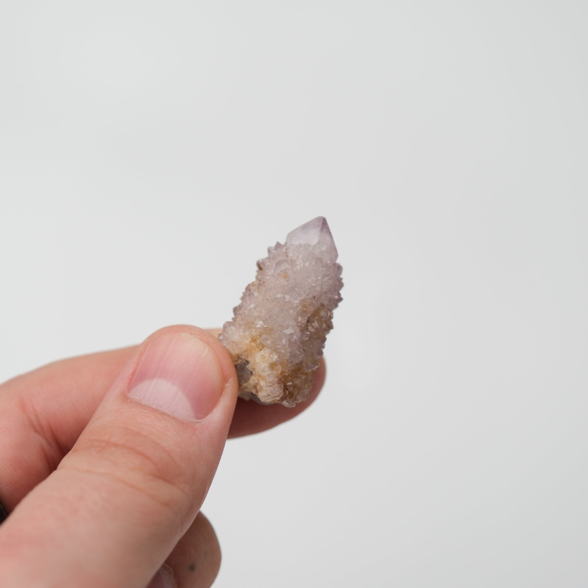 Noctis Studio Spirit Quartz cluster with clear, elongated crystal formations and vibrant purple and white hues.