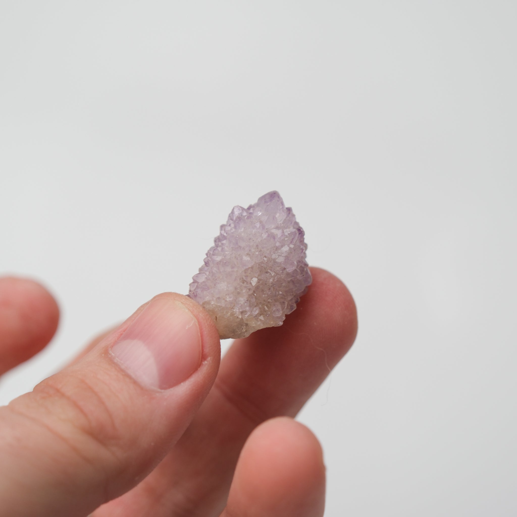 Noctis Studio Spirit Quartz cluster with clear, shimmering crystal points arranged in a natural formation on a neutral background.