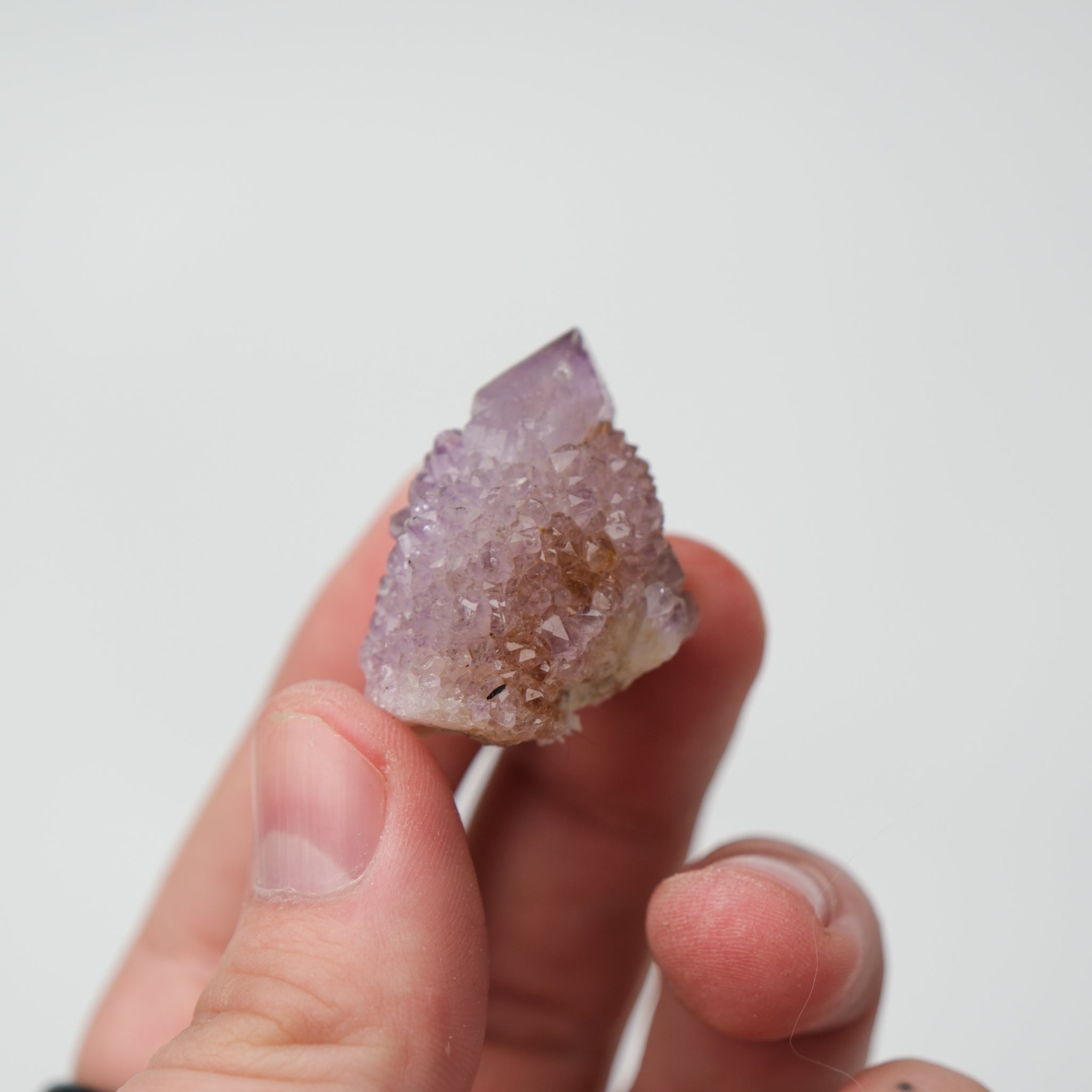 Noctis Studio Spirit Quartz cluster featuring clear, purple, and white crystalline formations on a natural mineral base.