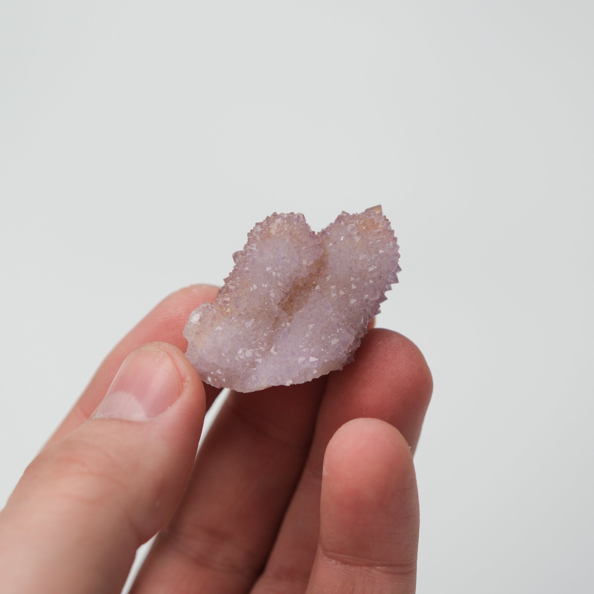 Natural spirit quartz cluster with clear, elongated crystals and a vibrant, glowing appearance from Noctis Studio.
