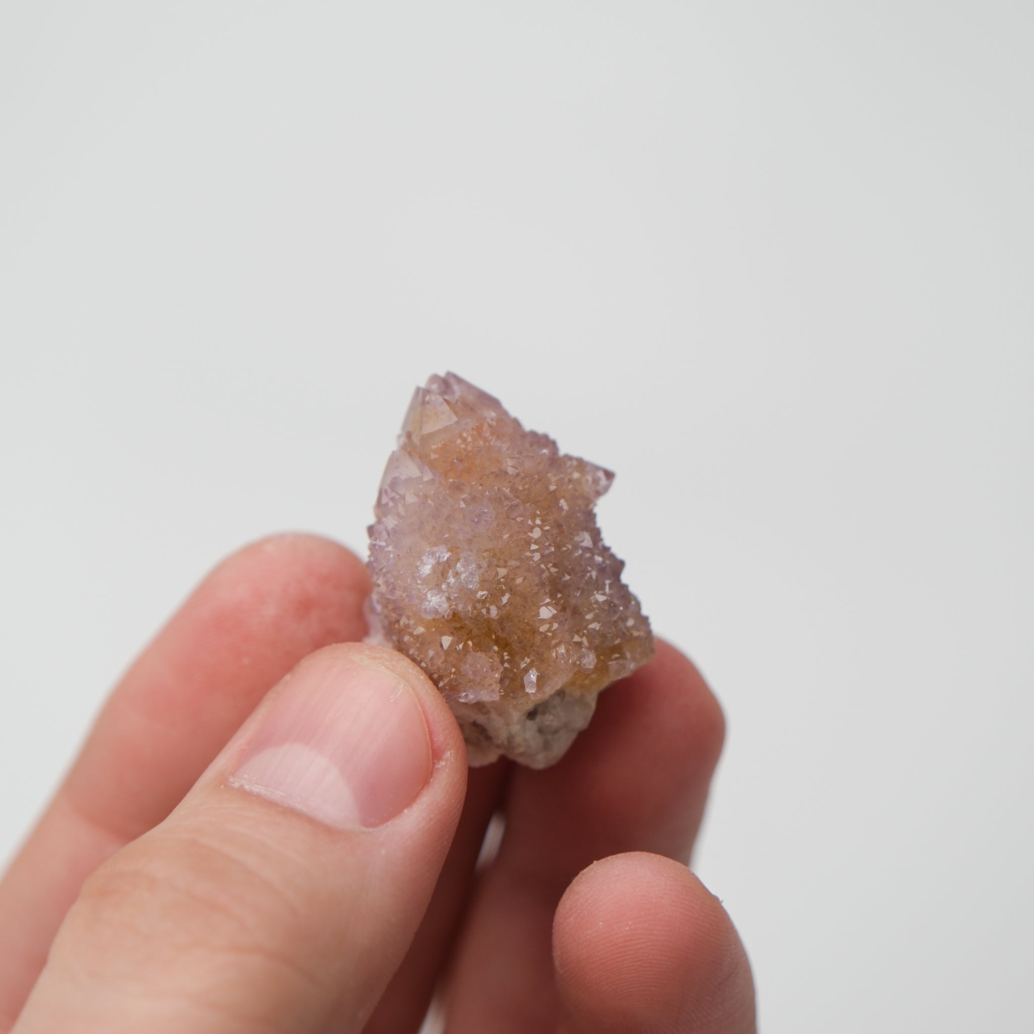 Noctis Studio Spirit Quartz cluster showing multiple transparent, violet crystal points with a natural mineral base.