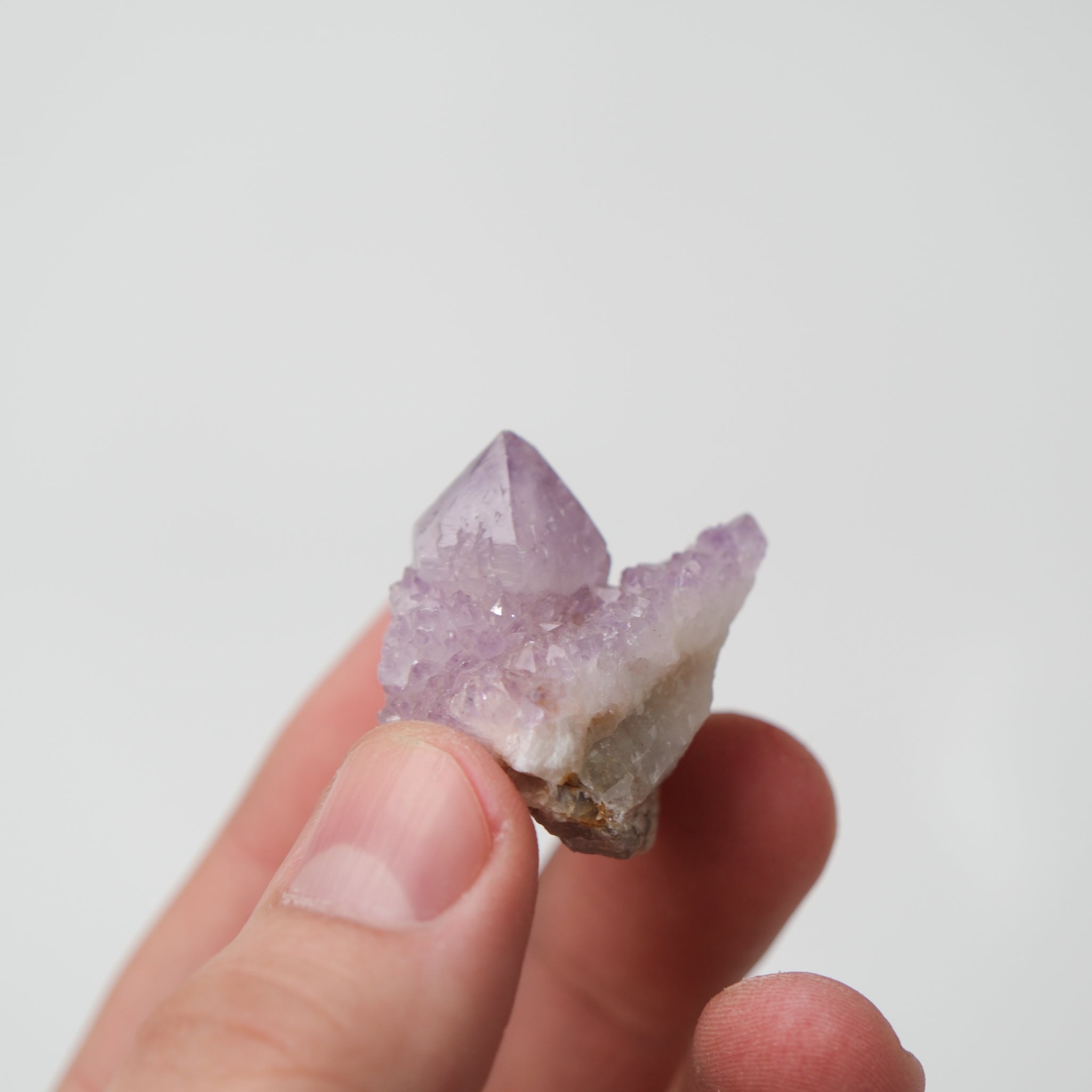 Noctis Studio Spirit Quartz cluster with clear, elongated crystals arranged in a natural formation on a neutral background.