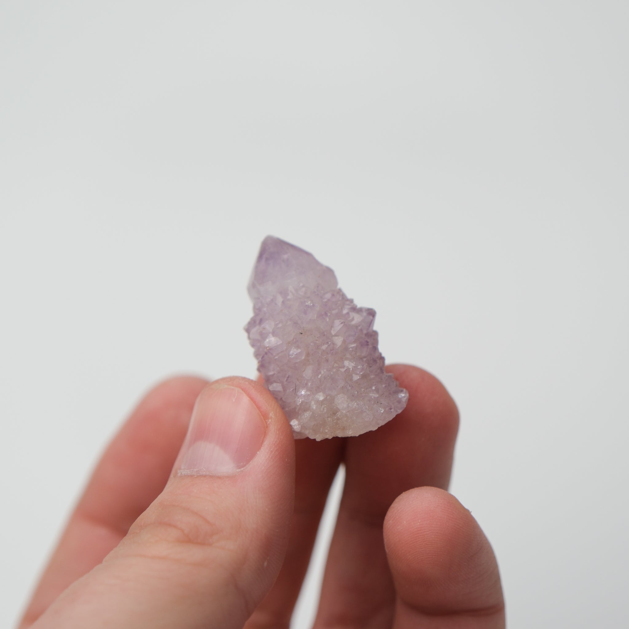 Noctis Studio Spirit Quartz cluster featuring multiple translucent, pale purple crystal points arranged in a natural formation.