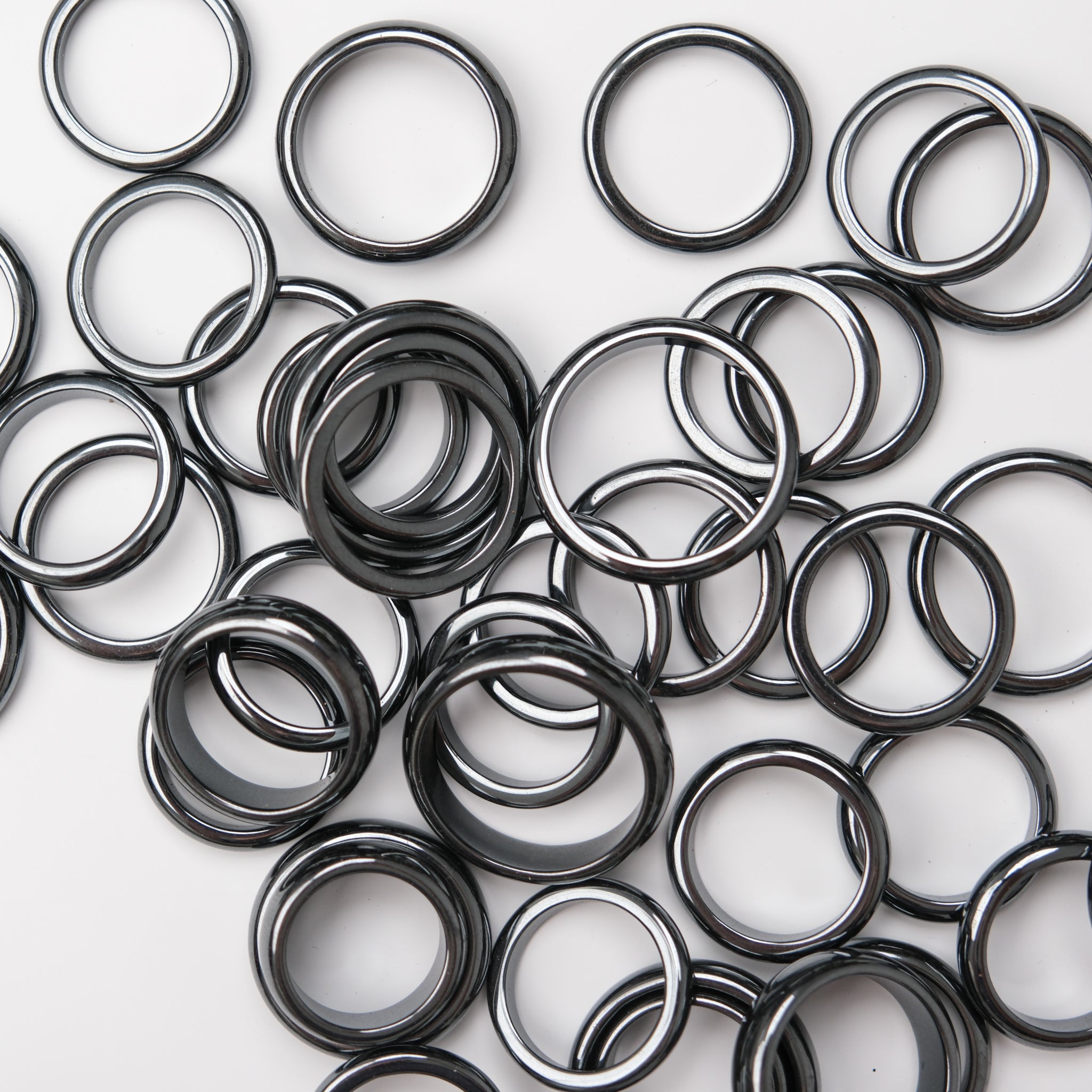 Two hematite rings with crystal stands from Noctis Studio, displayed on a neutral background.