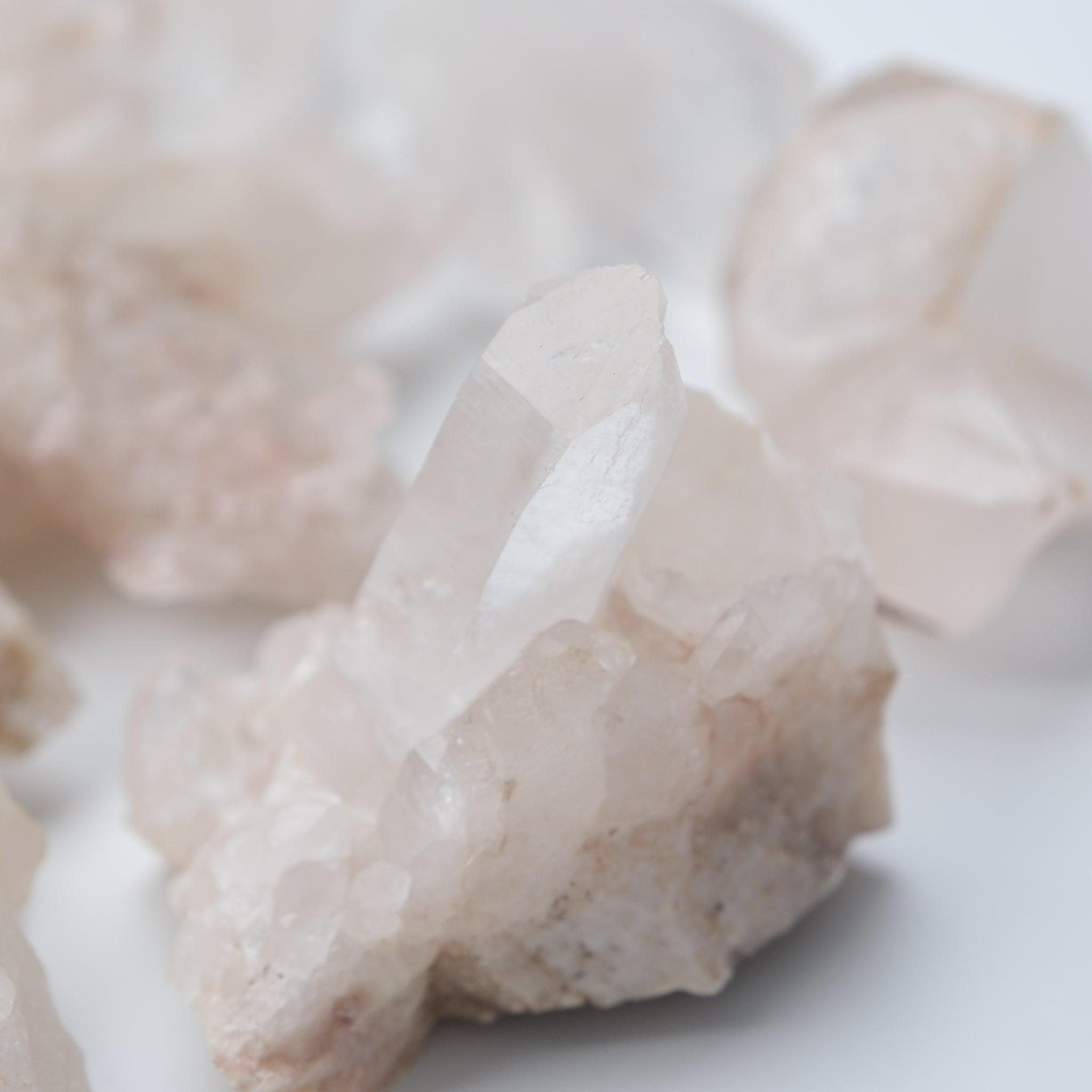 Himalayan quartz crystal cluster from Noctis Studio showing clear, pink-tinged quartz points arranged naturally.