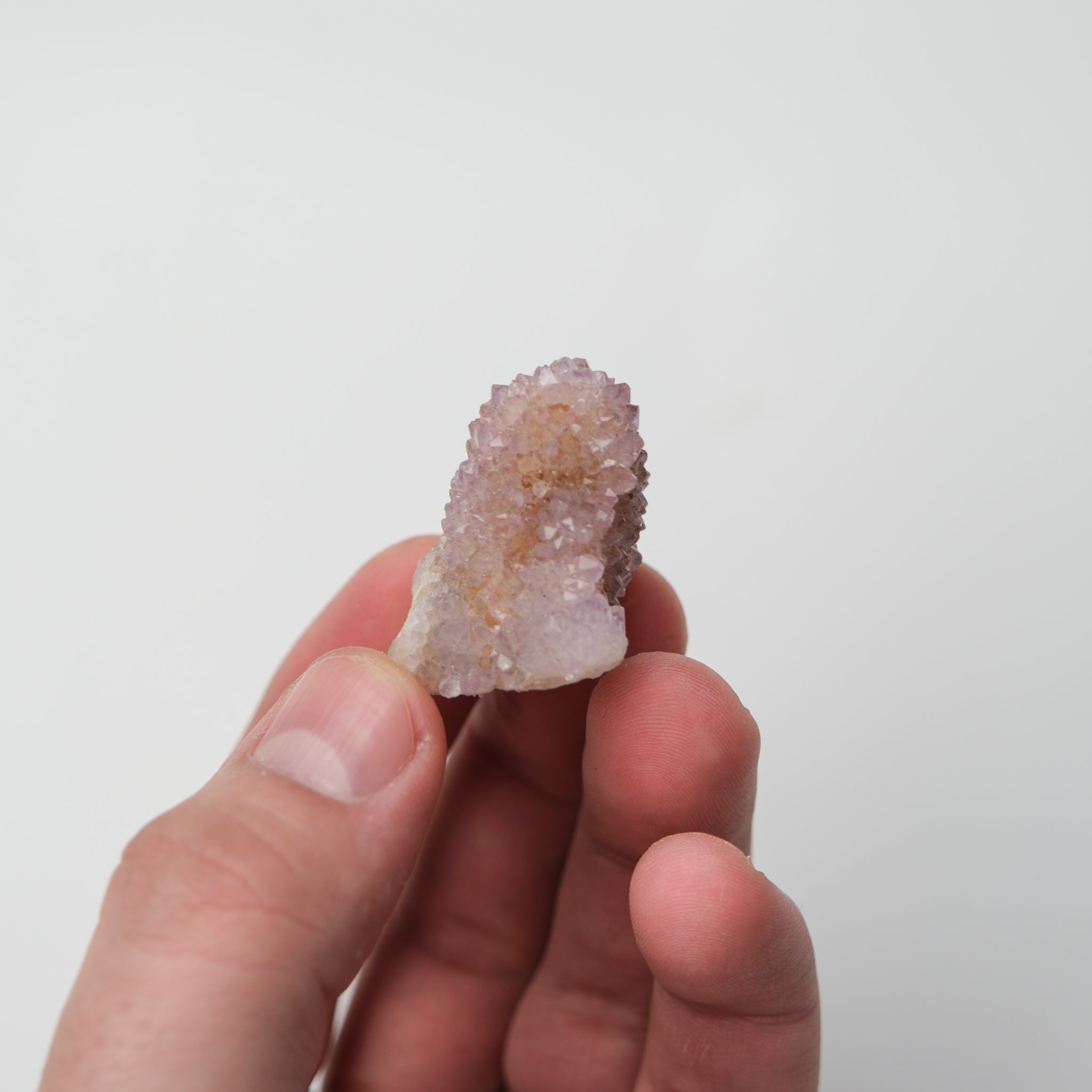 Noctis Studio Spirit Quartz cluster with clear, elongated crystals arranged in a natural formation on a neutral background.