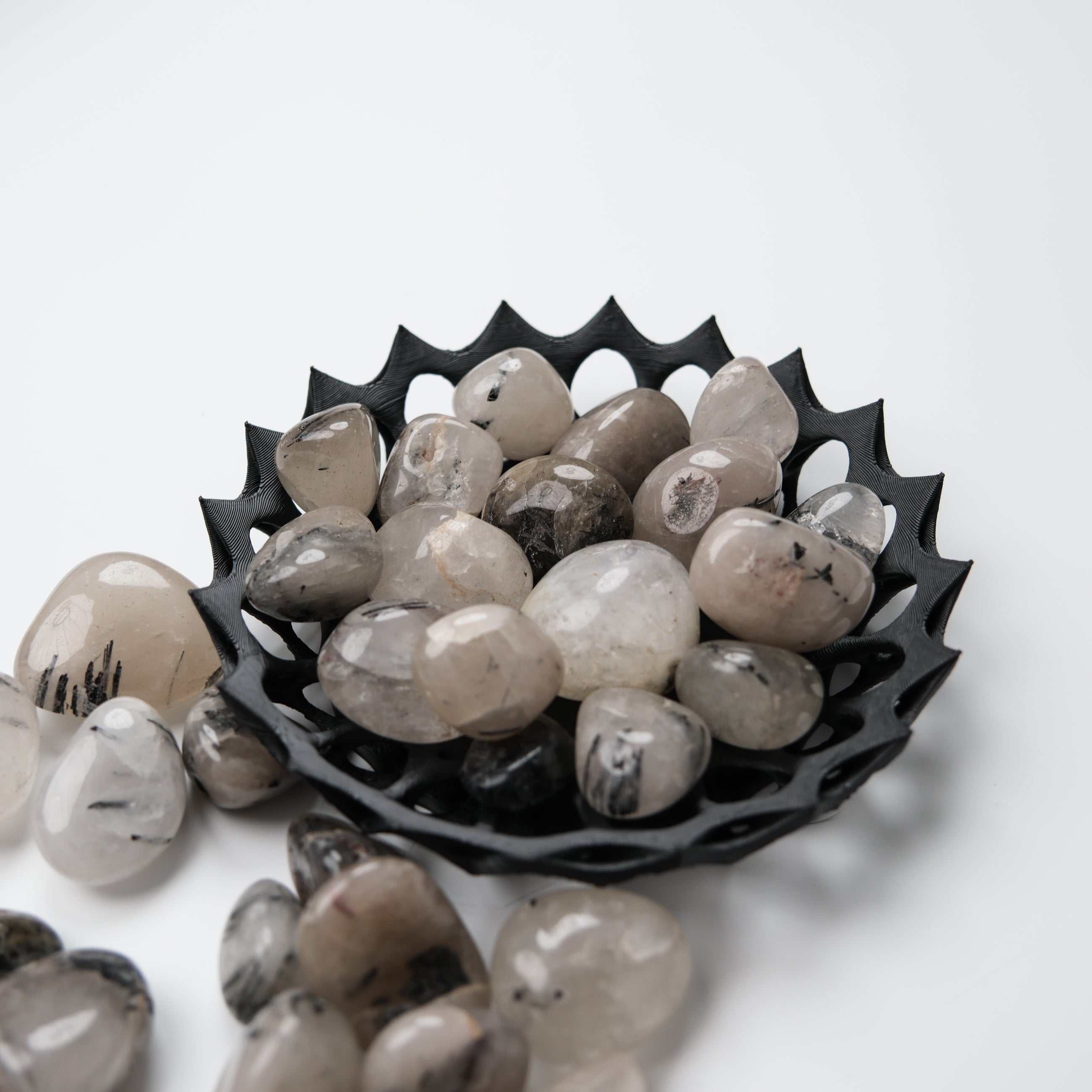 Tourmalinated Quartz tumble stone by Noctis Studio showing black tourmaline inclusions in clear quartz crystal.