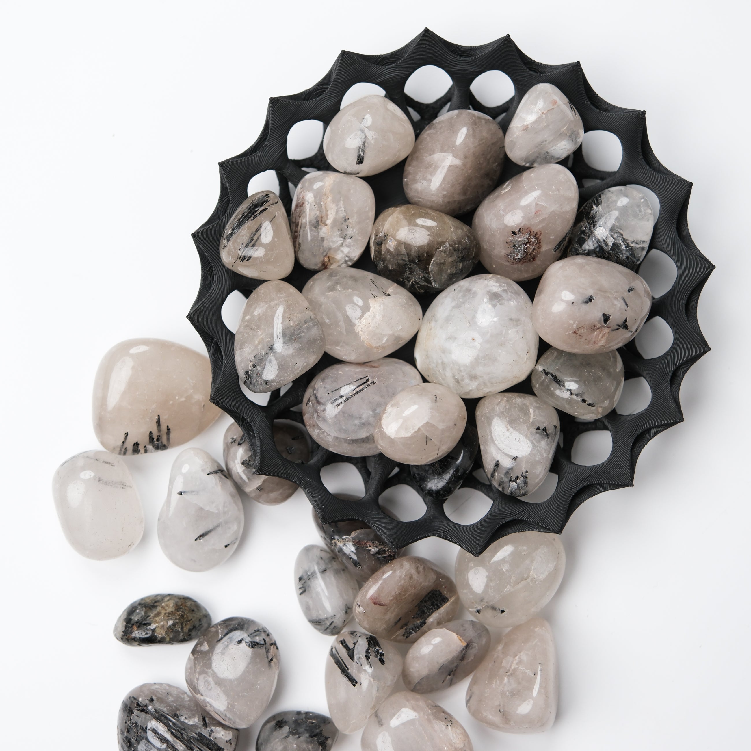 Tourmalinated Quartz tumble stone from Noctis Studio showing black tourmaline inclusions in clear quartz crystal.