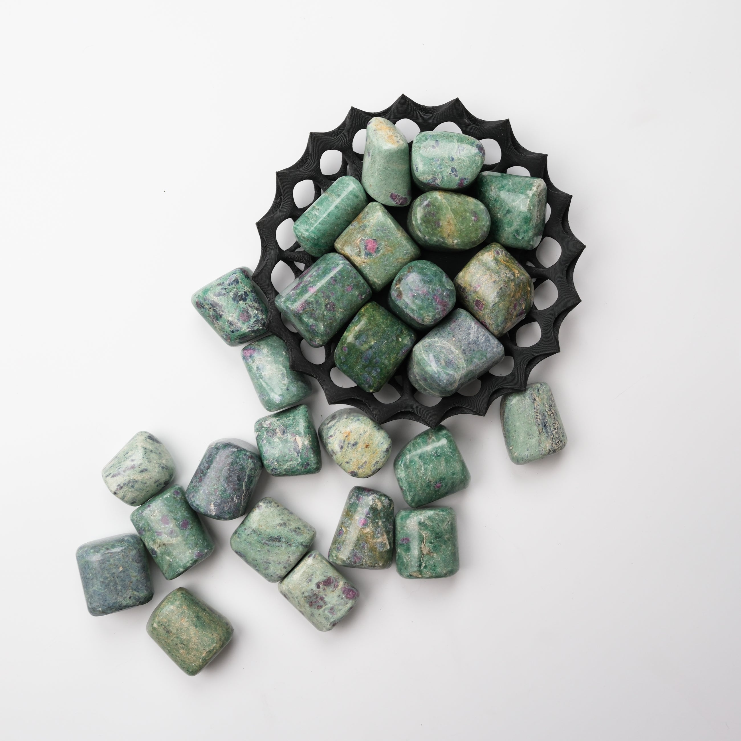 Ruby in Fuschite tumble stone from Noctis Studio showing vibrant red ruby and green fuschite mineral patterns.
