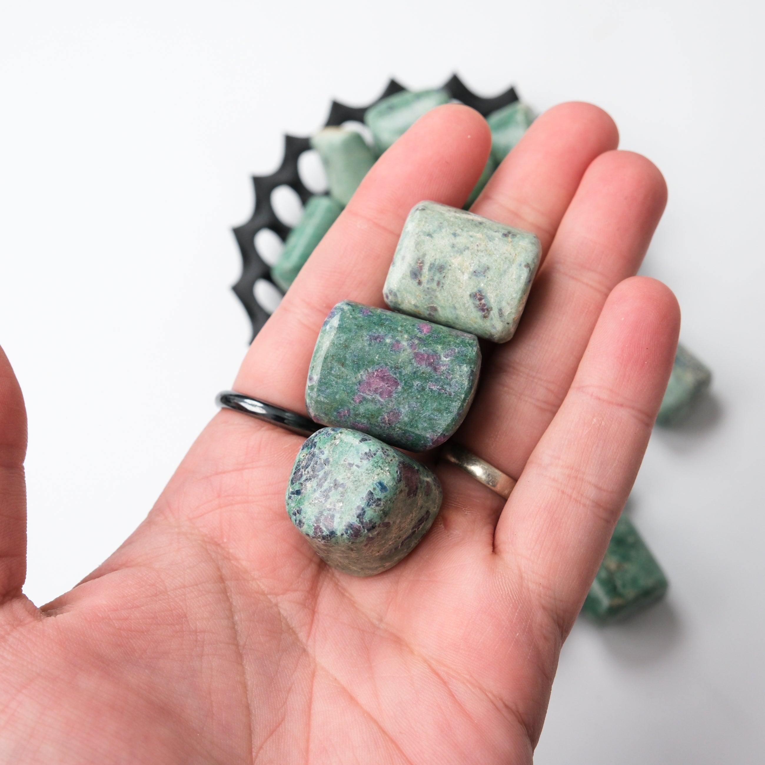 Ruby in Fuschite tumble stone from Noctis Studio, showing a polished stone with vibrant red ruby and green fuschite mineral inclusions.