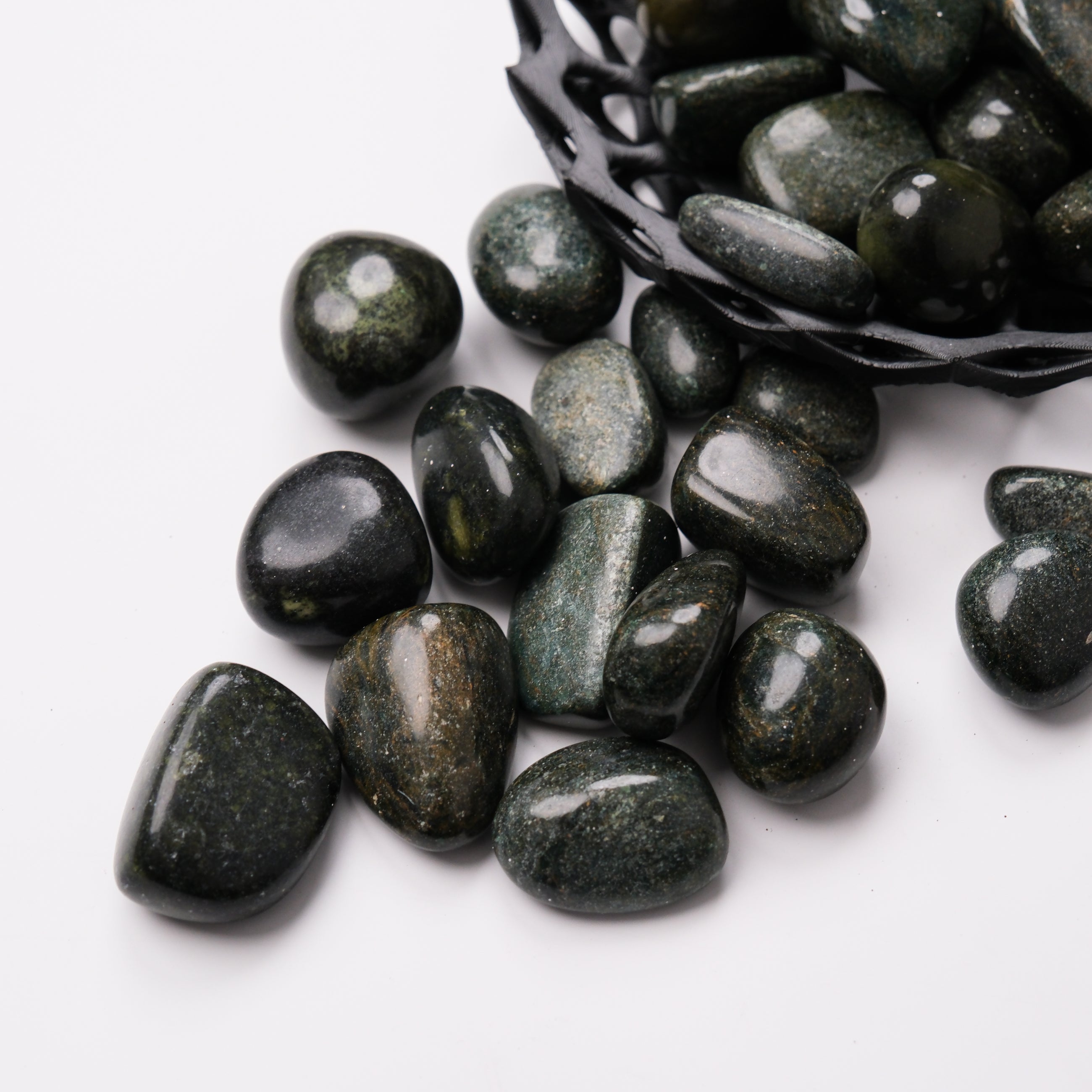 Noctis Studio Verdite tumble stone showing smooth green and brown mineral patterns on polished surface.