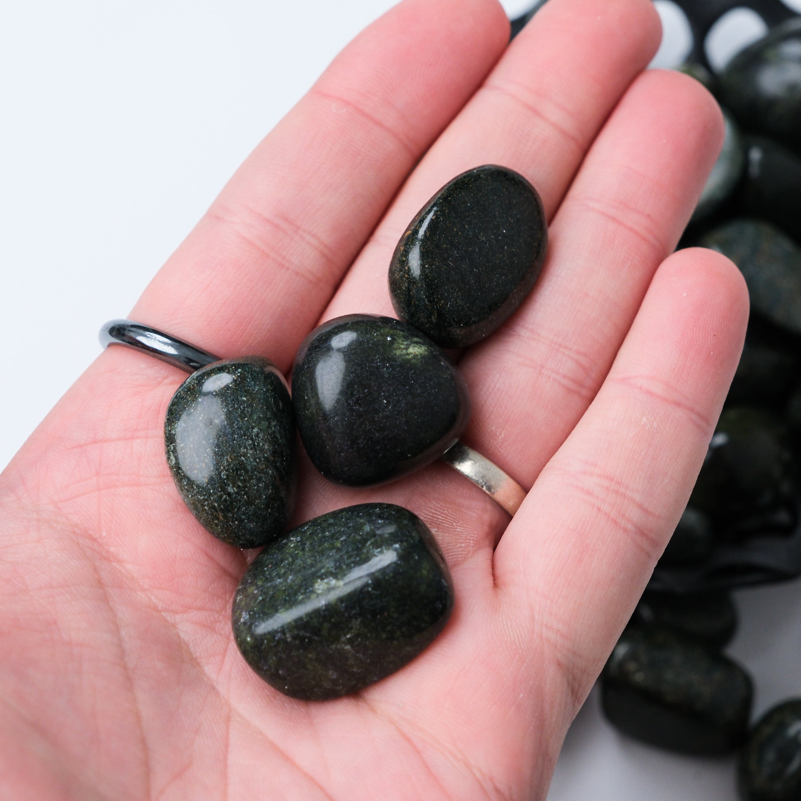 Noctis Studio Verdite tumble stone with rich green and brown hues, polished and smooth, showcasing natural mineral patterns.