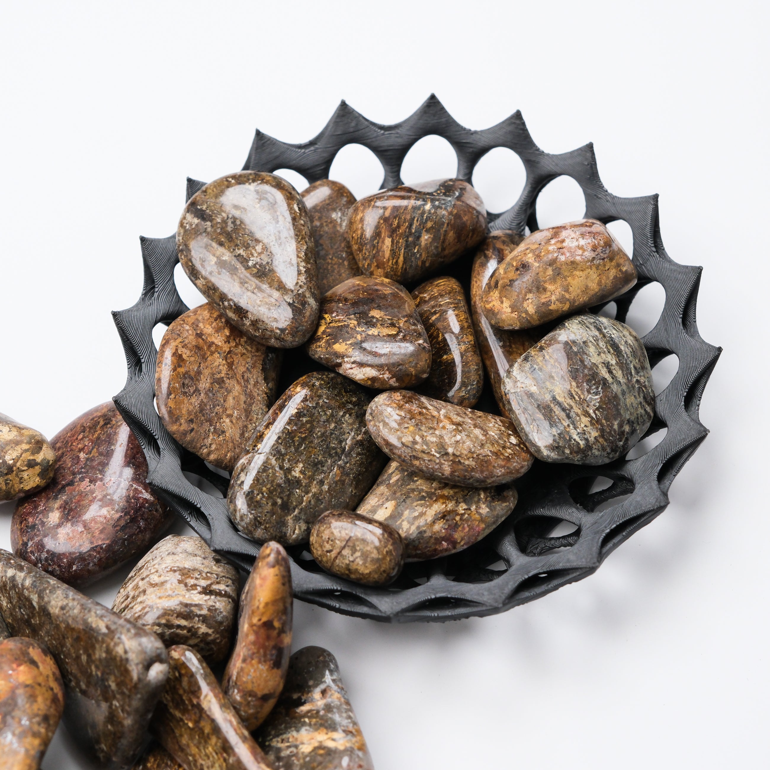Bronzite tumble stone from Noctis Studio, showing polished, rounded mineral with warm bronze hues and natural surface texture.