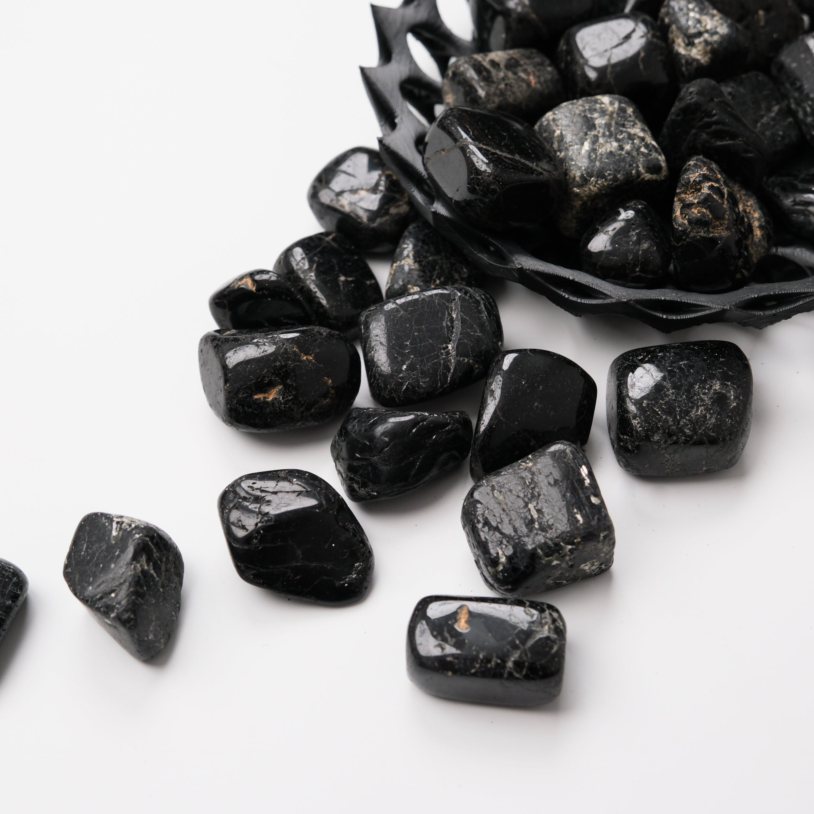 Black Tourmaline tumble stone from Noctis Studio, polished mineral with a smooth, rounded black appearance.
