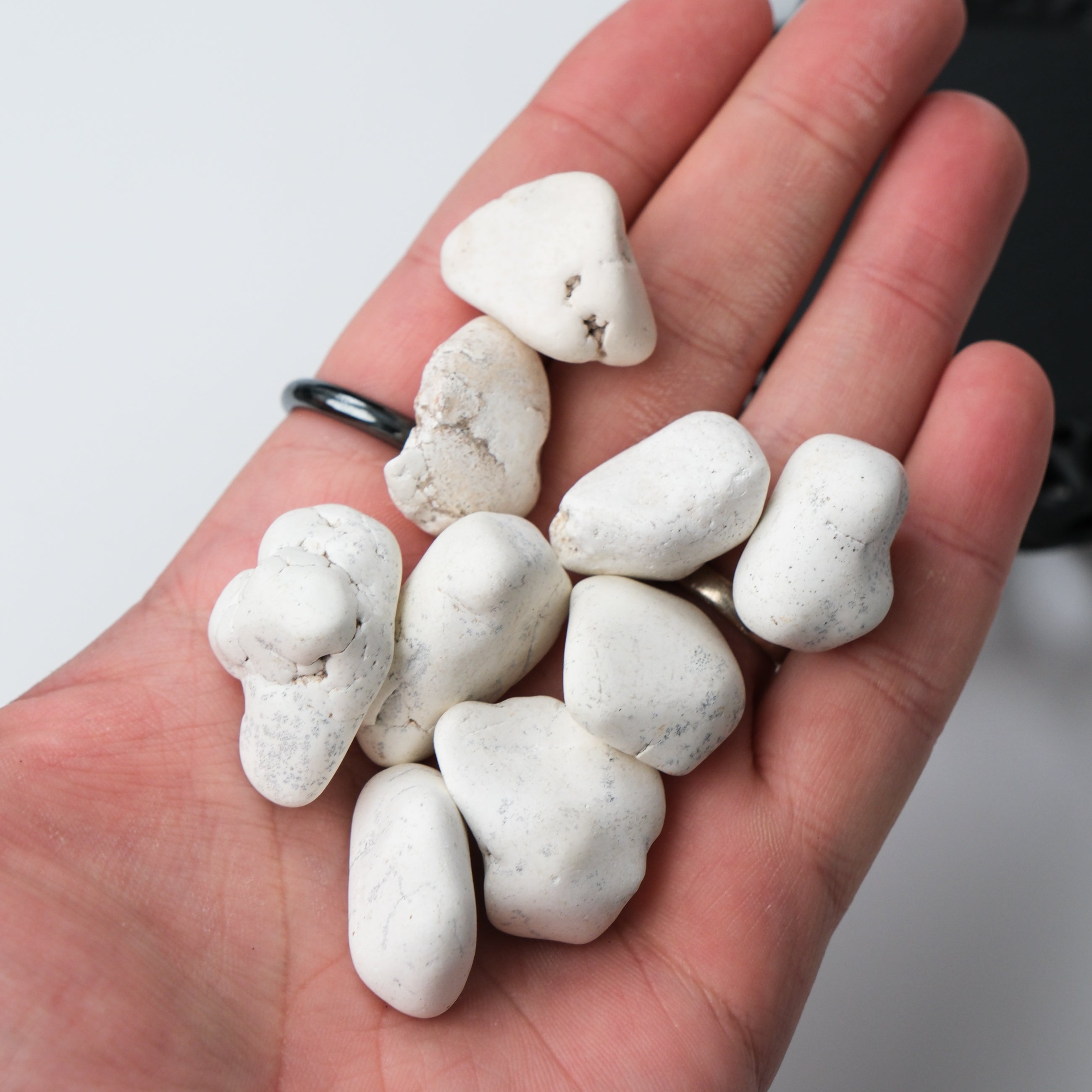 White Magnesite tumble stone from Noctis Studio, showcasing smooth, polished mineral with a soft white appearance.