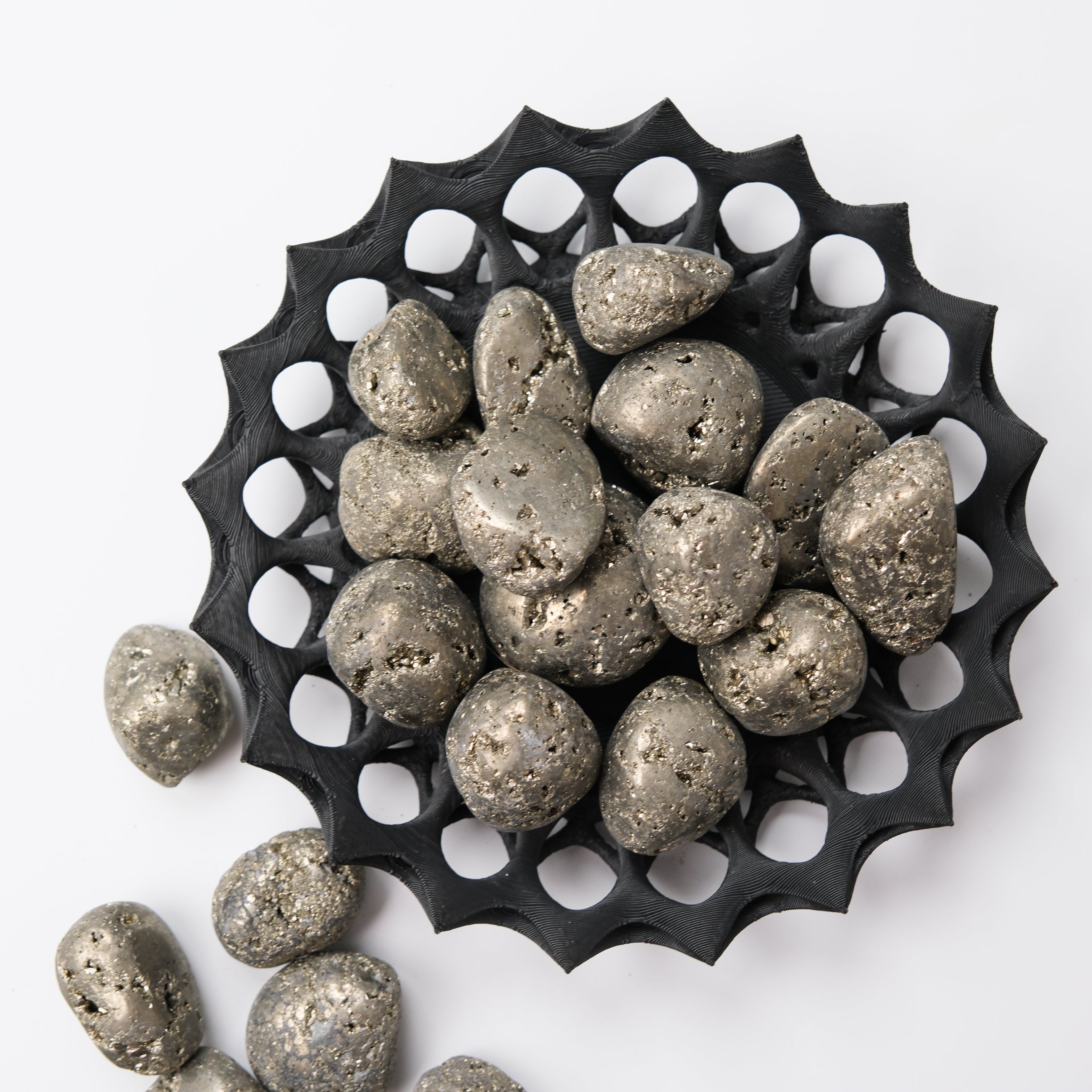 Noctis Studio Pyrite tumble stone showing metallic gold and brassy mineral surface on a smooth rounded rock.