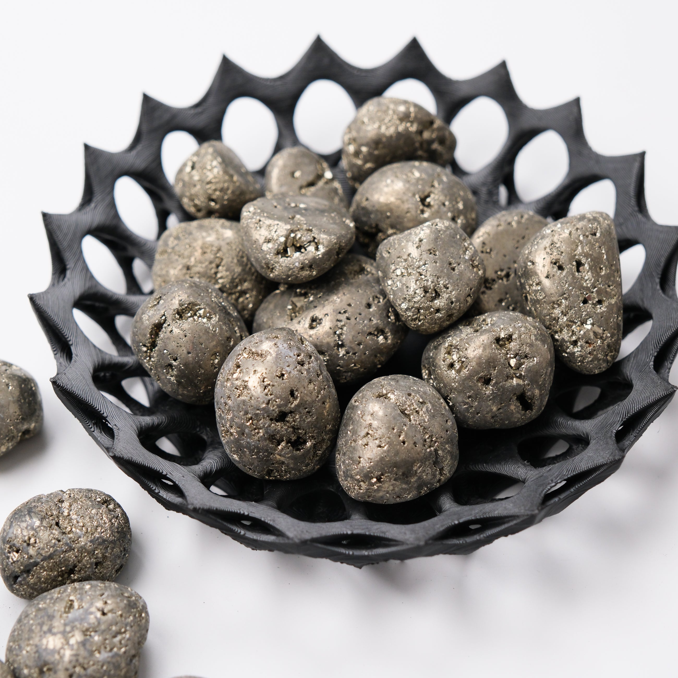 Smooth pyrite tumble stone from Noctis Studio, showcasing metallic gold sheen and natural textured surface.