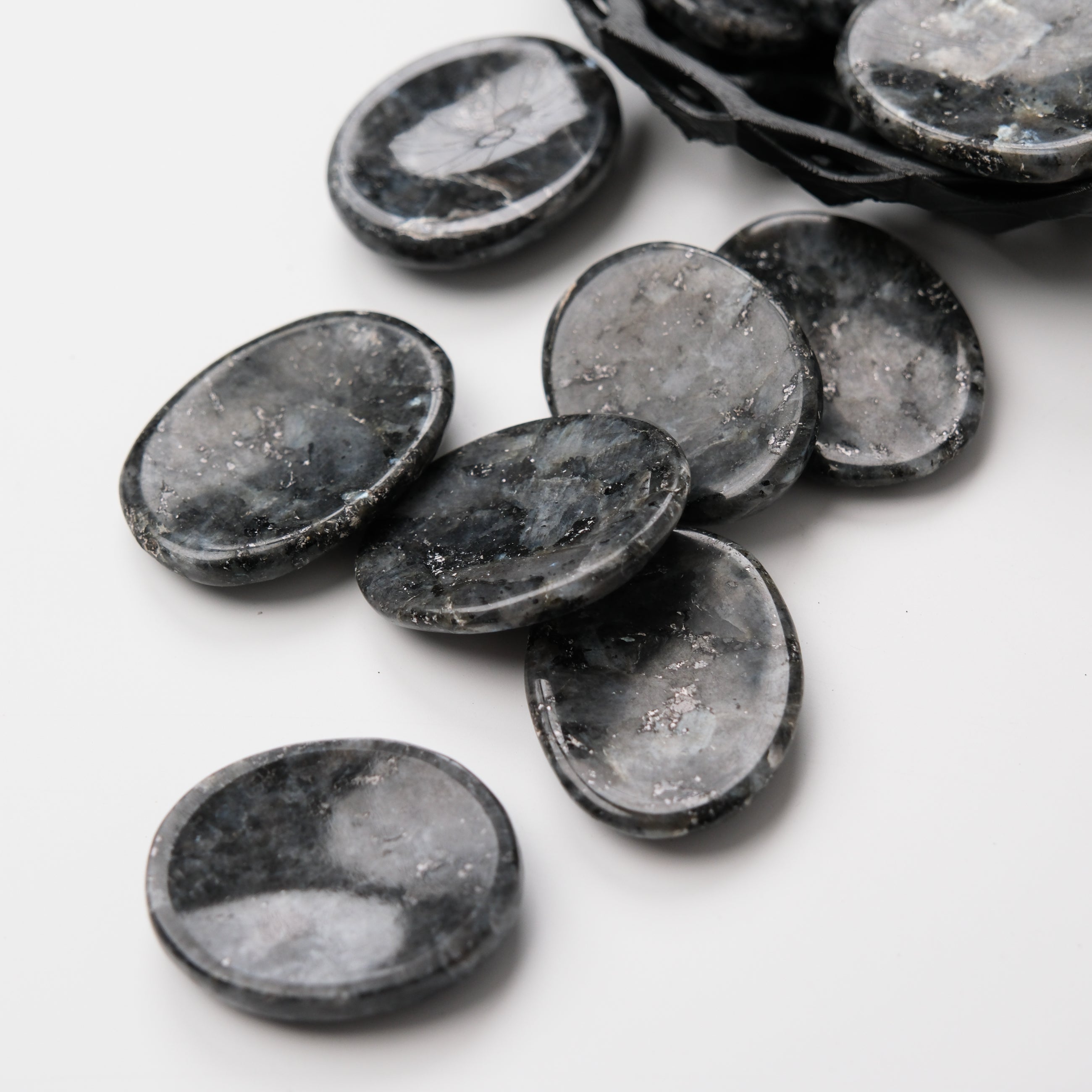Larvikite worry stone from Noctis Studio showing smooth polished surface and natural dark gray and blue hues.