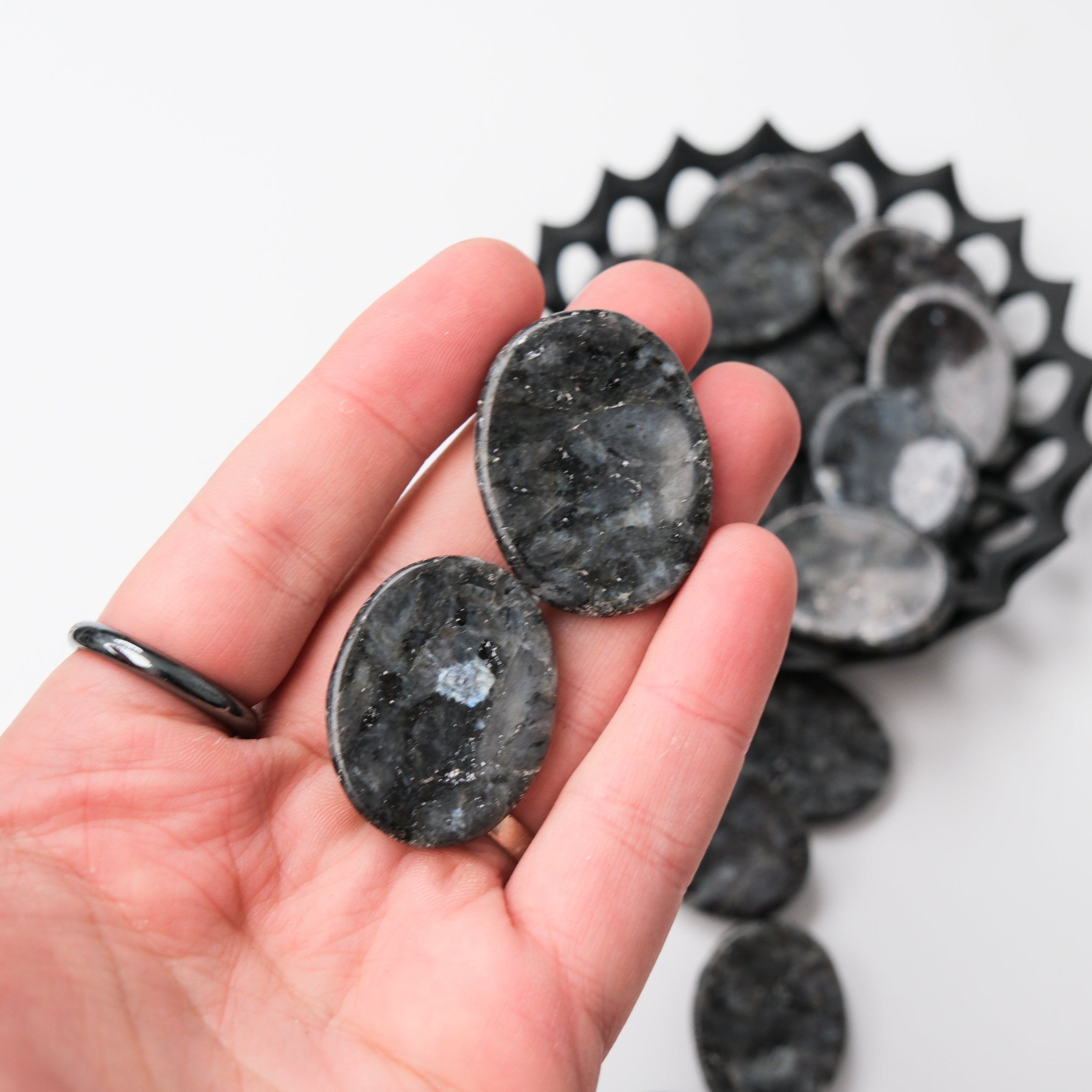 Larvikite worry stone from Noctis Studio, smooth polished gemstone for calming grip and meditation.