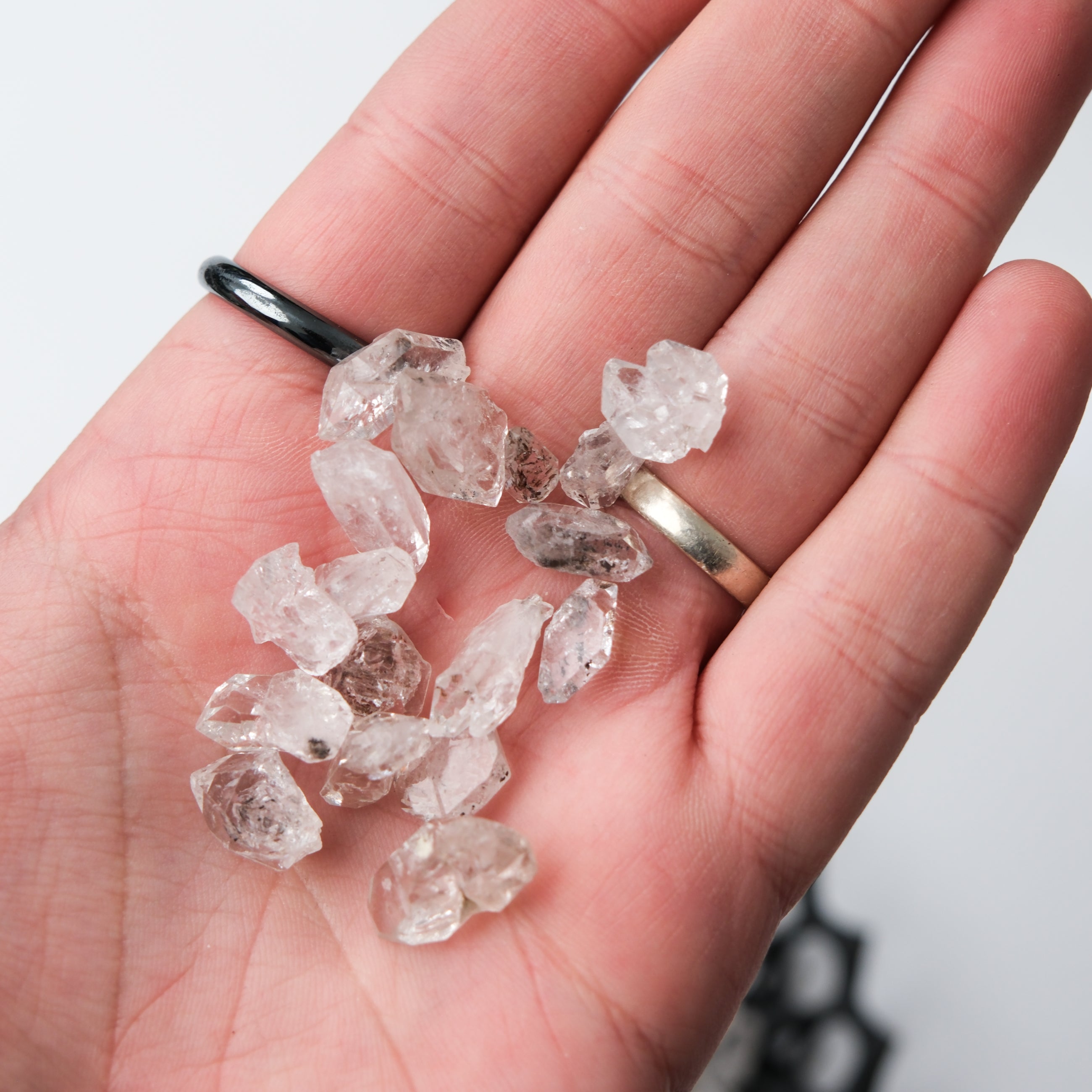 Diamond Quartz tumble stone from Noctis Studio, showcasing a polished, translucent gemstone with a sparkling, faceted surface.