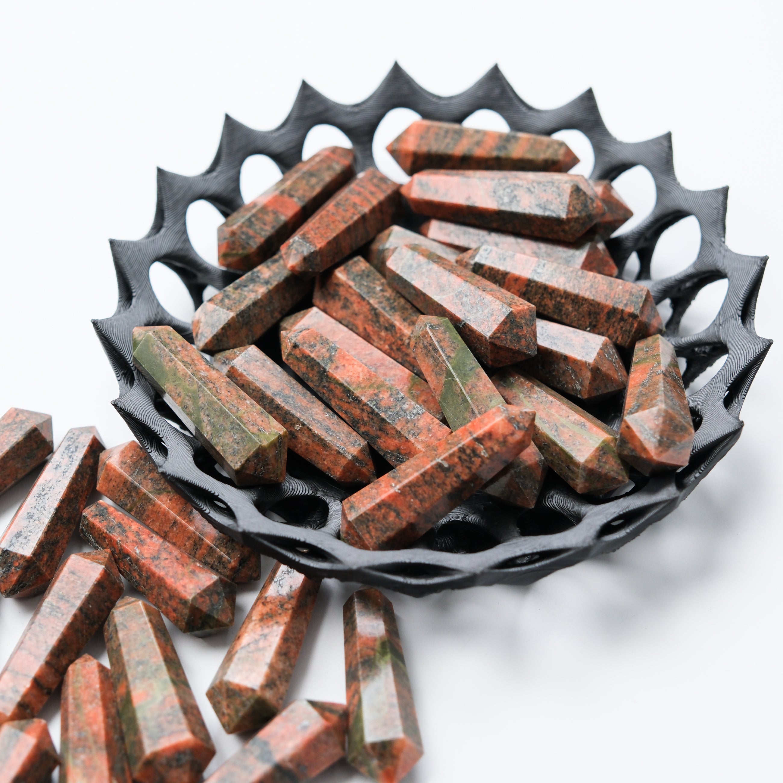 Unakite double gridding point by Noctis Studio showing smooth, polished stone with detailed, symmetrical design for crystal healing.